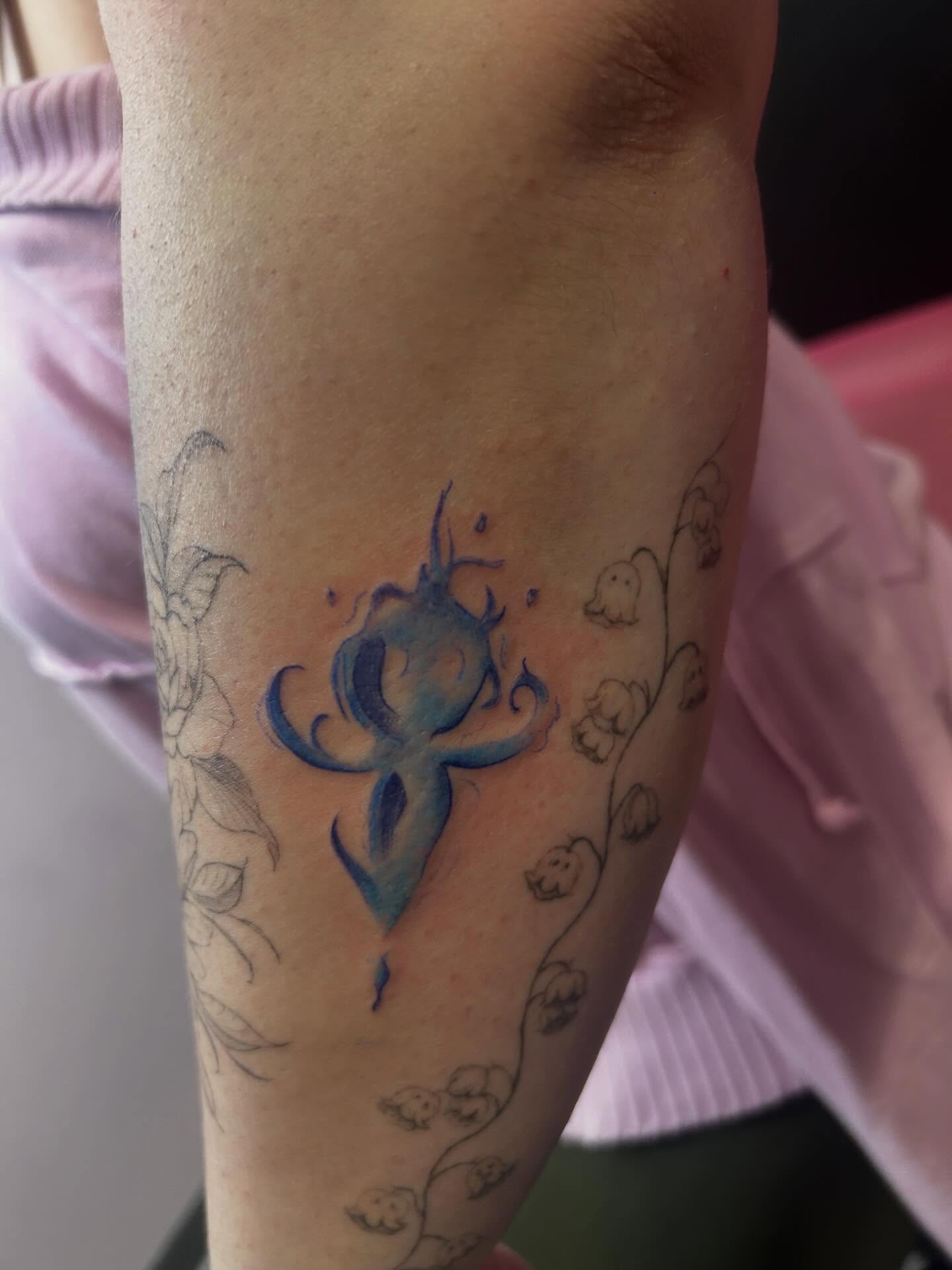 Abstract symbol watercolor tattoo on the forearm by Big Mar, Rocky Hill, Connecticut