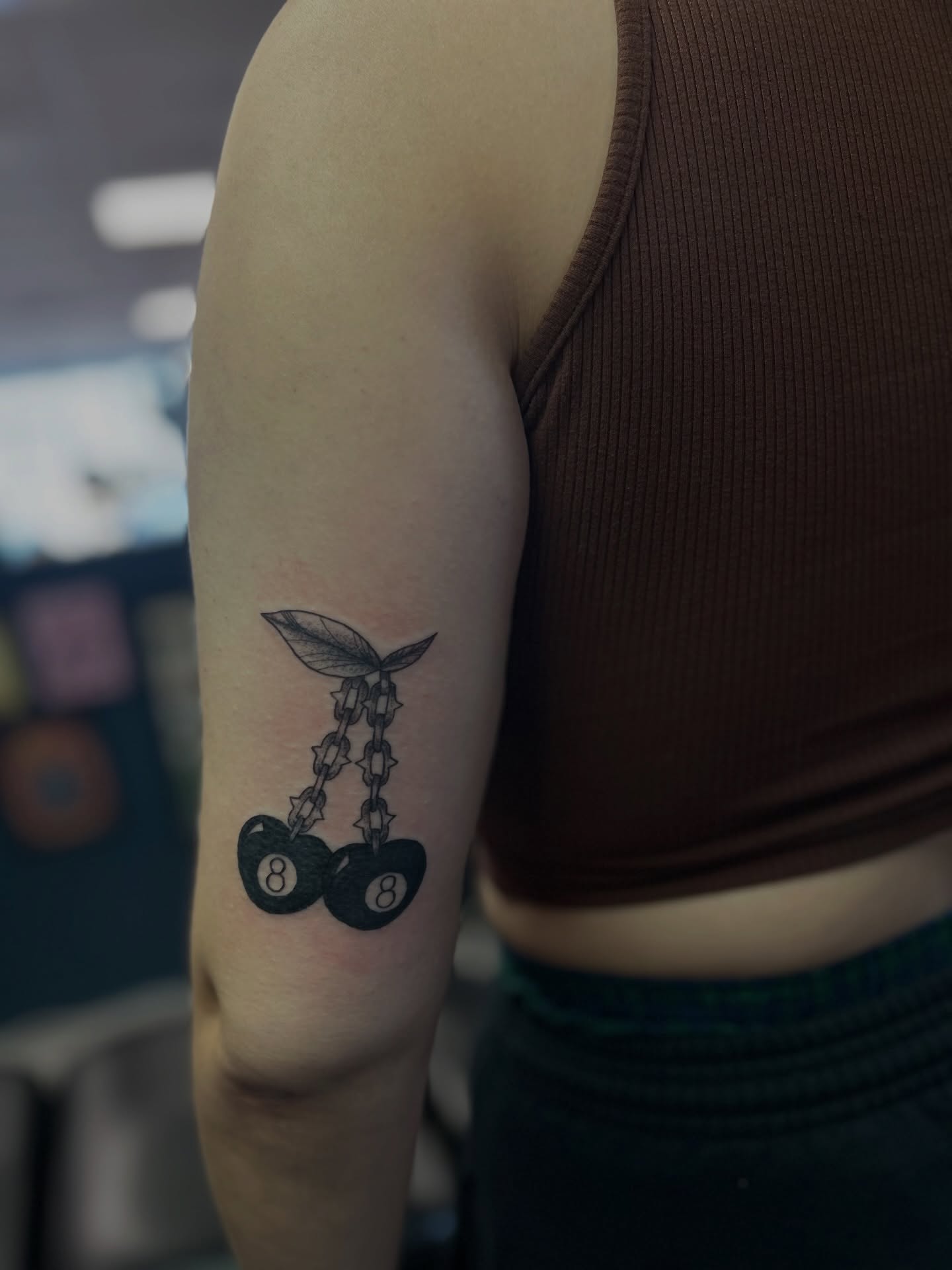 Cherry and chain black and grey tattoo on the forearm by Torrey, Austin, Texas