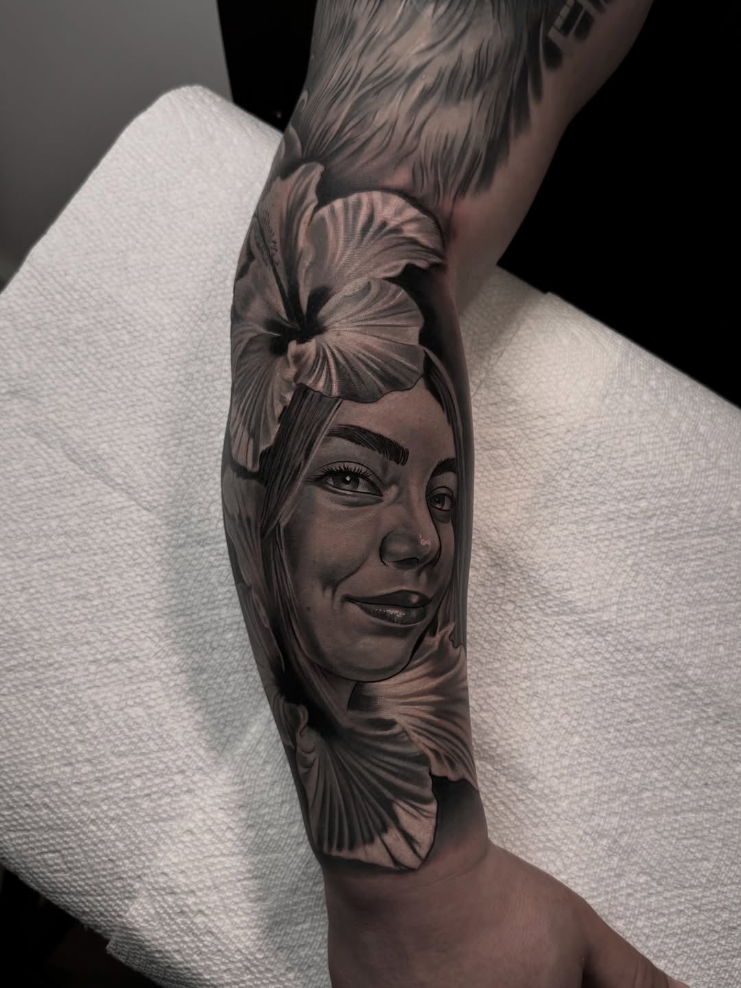 Portrait of a woman with flowers realism tattoo on the forearm by Luis Manuel Olivera, North Miami, Florida