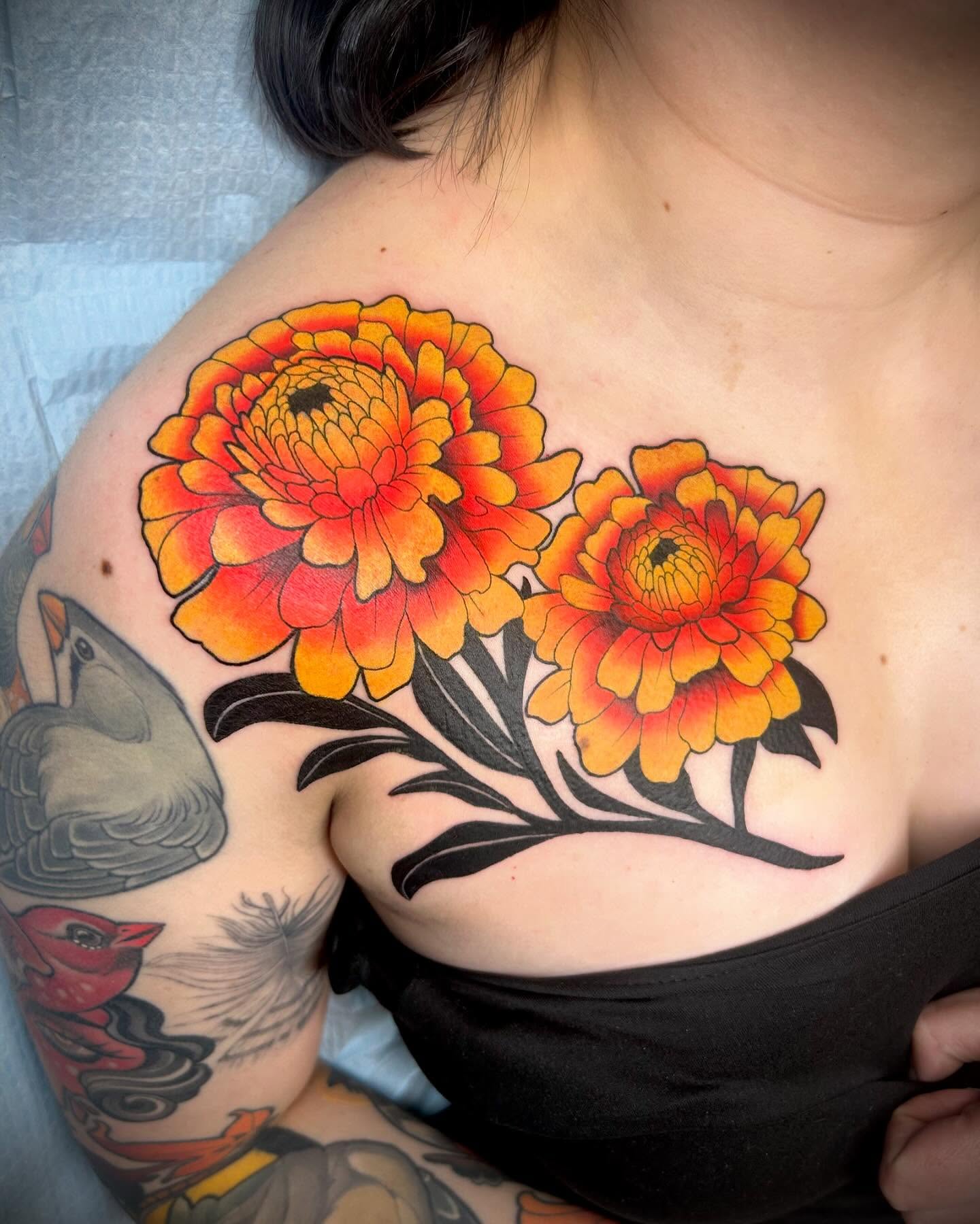 Marigolds American traditional tattoo on the chest by Steve Hooker