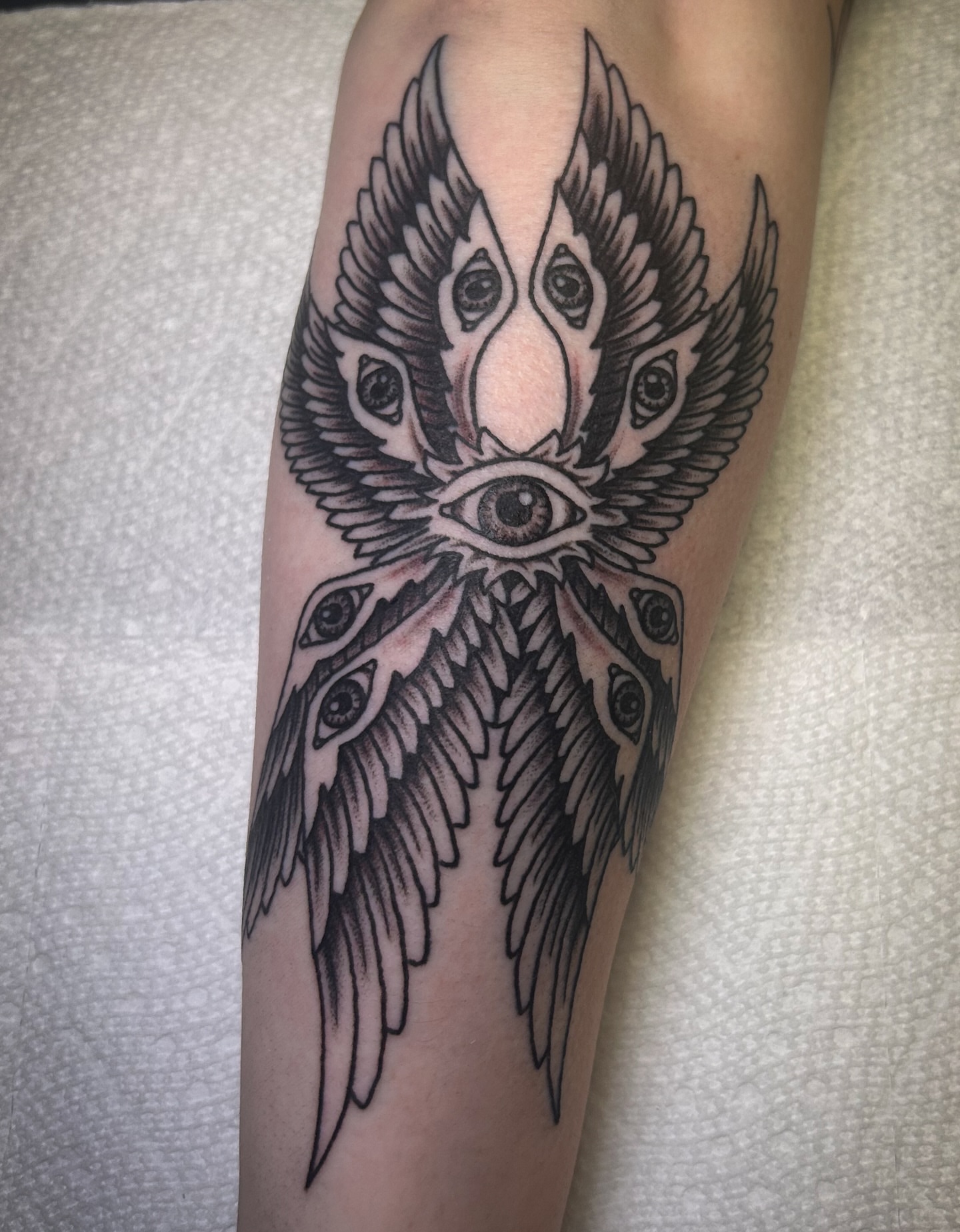 Wings and eyes black and grey tattoo on the forearm by Jessica Oram Brockman, Dayton, Ohio