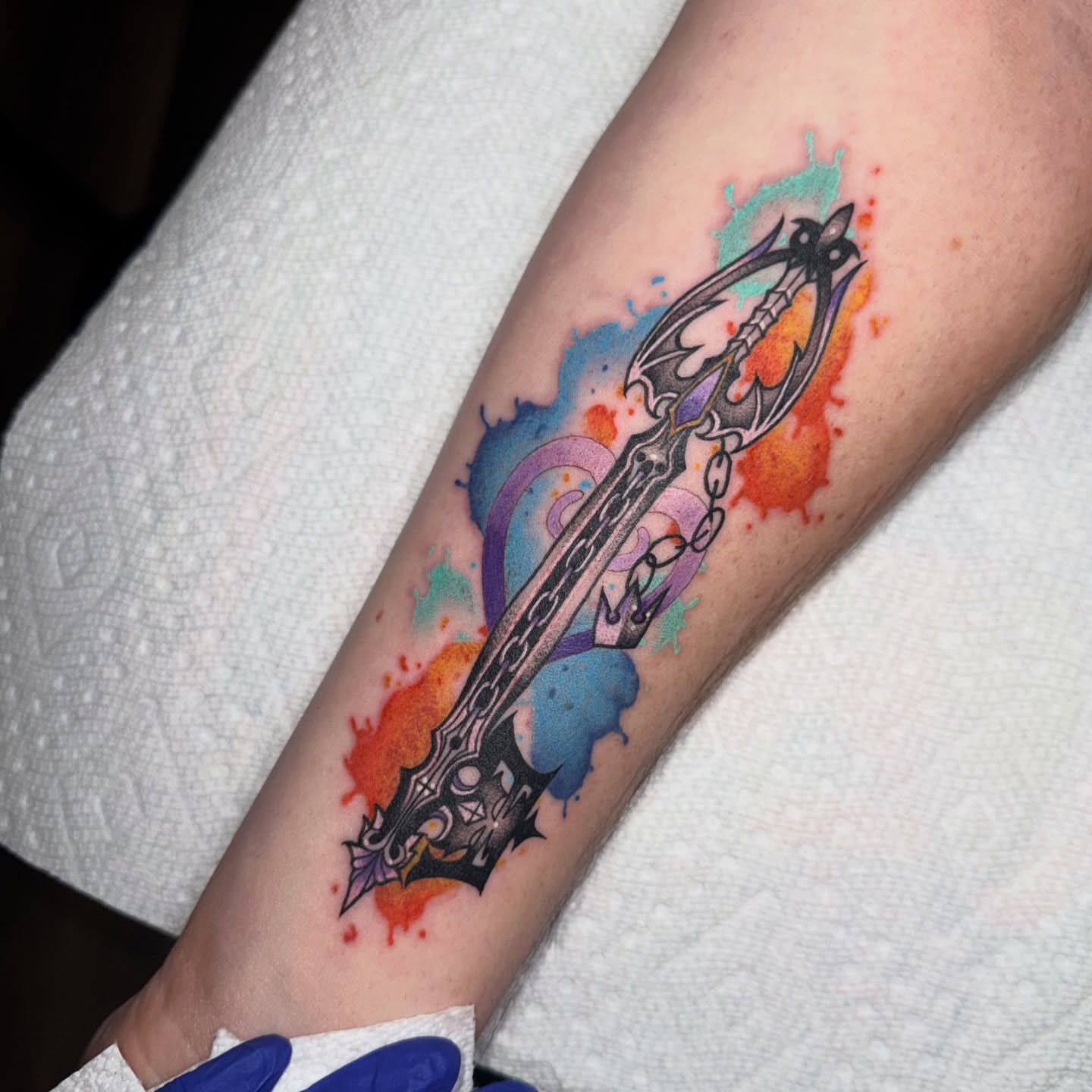 Sword watercolor tattoo on the forearm by Lyndze Masters