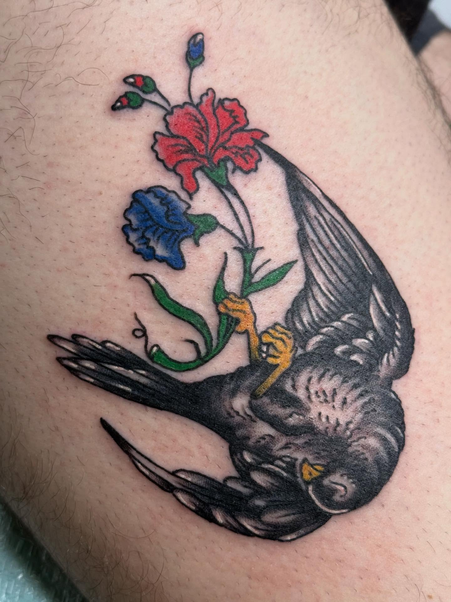 Bird and flowers American traditional tattoo on the thigh by Megan Sue Causemaker