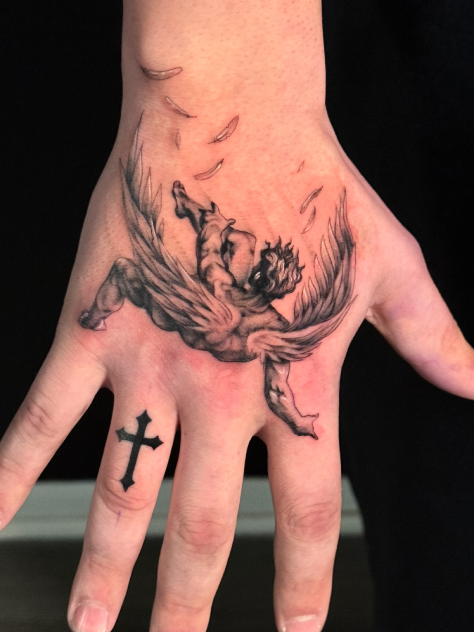 Falling angel black and grey tattoo on the hand by HAiZiE