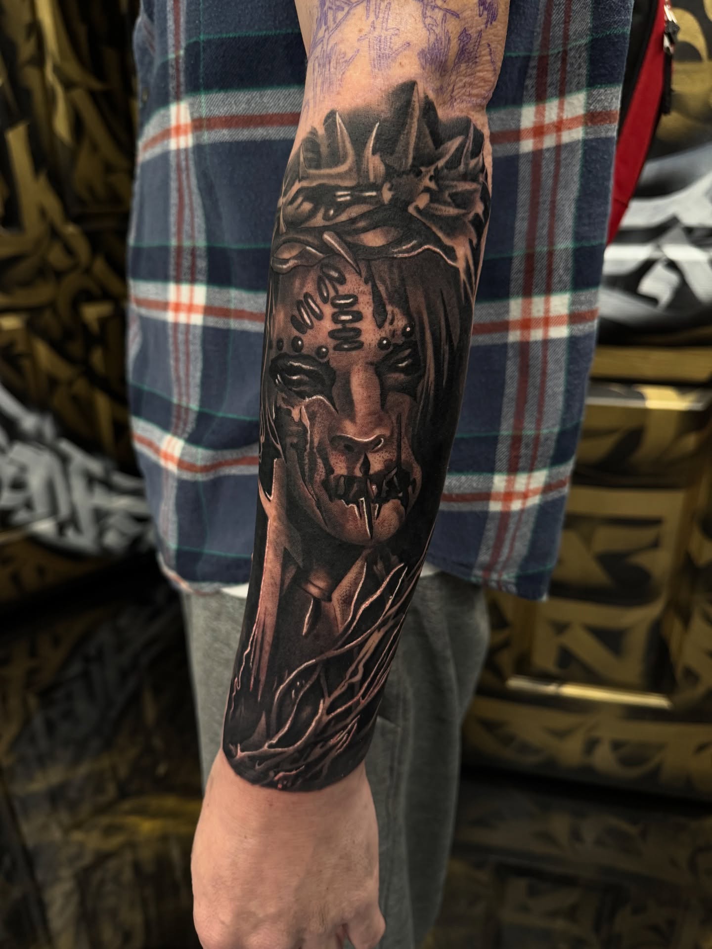 Mask dark realism tattoo on the forearm by Fernando Luna