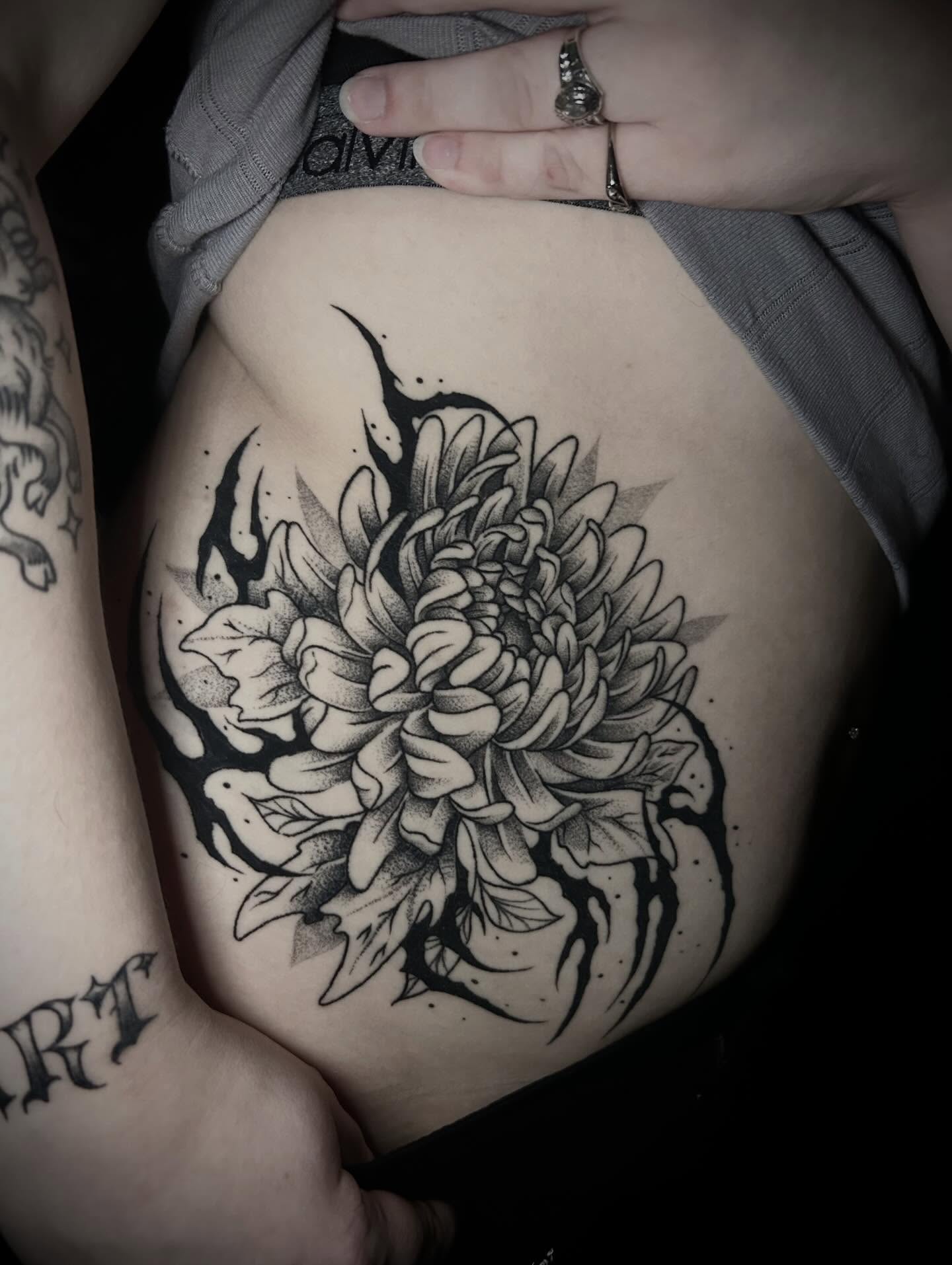 Chrysanthemum dotwork tattoo on the ribs by Heaven Arianna
