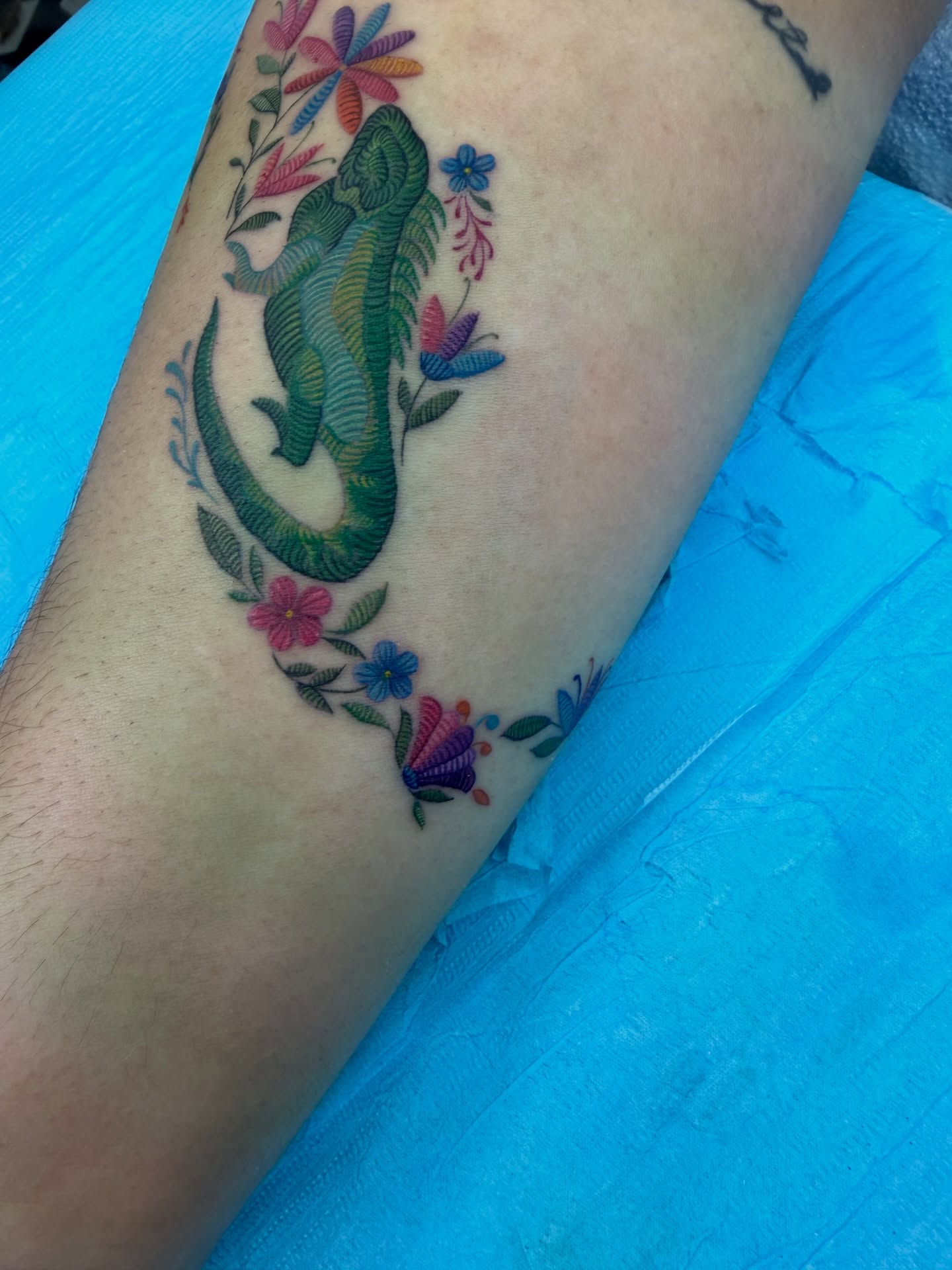 Lizard and flowers new school tattoo on the forearm by Melissa Rose Moya