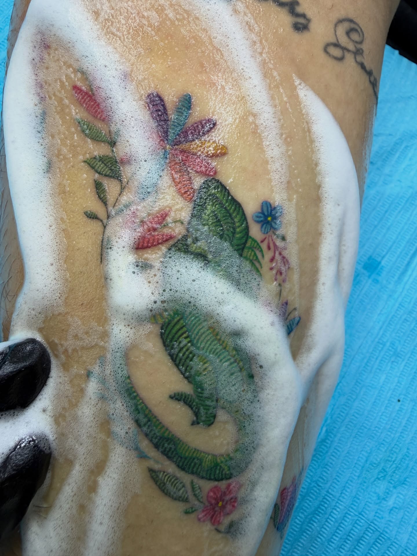Lizard and flowers new school tattoo on the forearm by Melissa Rose Moya