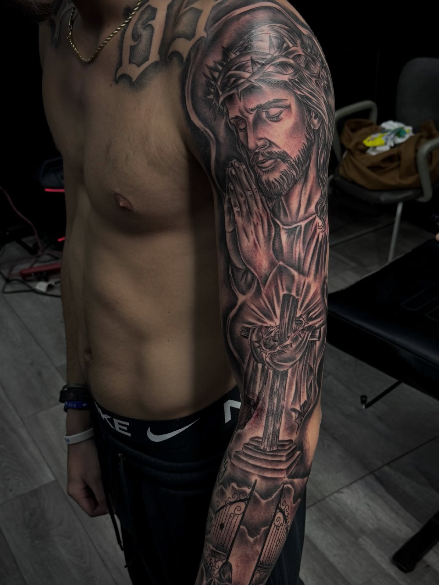 Praying jesus realism tattoo on the upper arm by Zeus