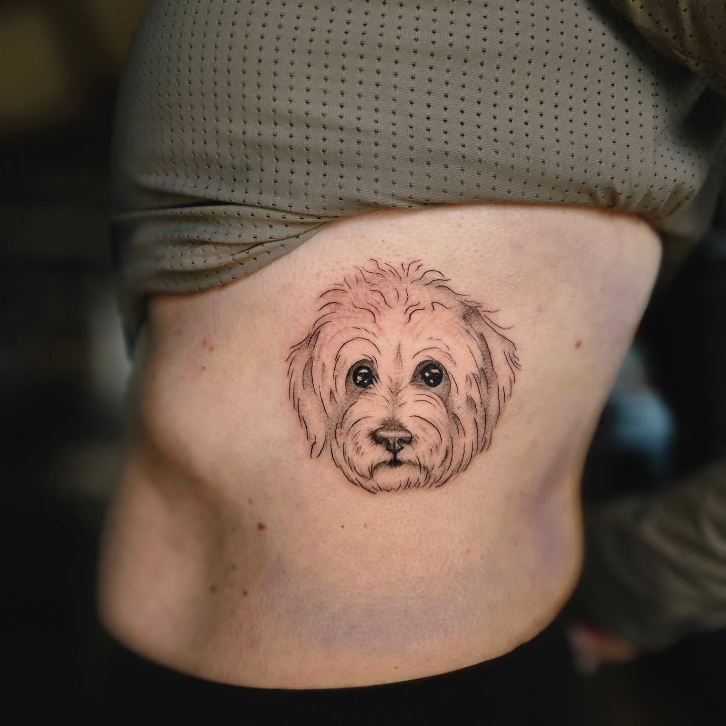 Dog realism tattoo on the torso by Courtlyn Bliss