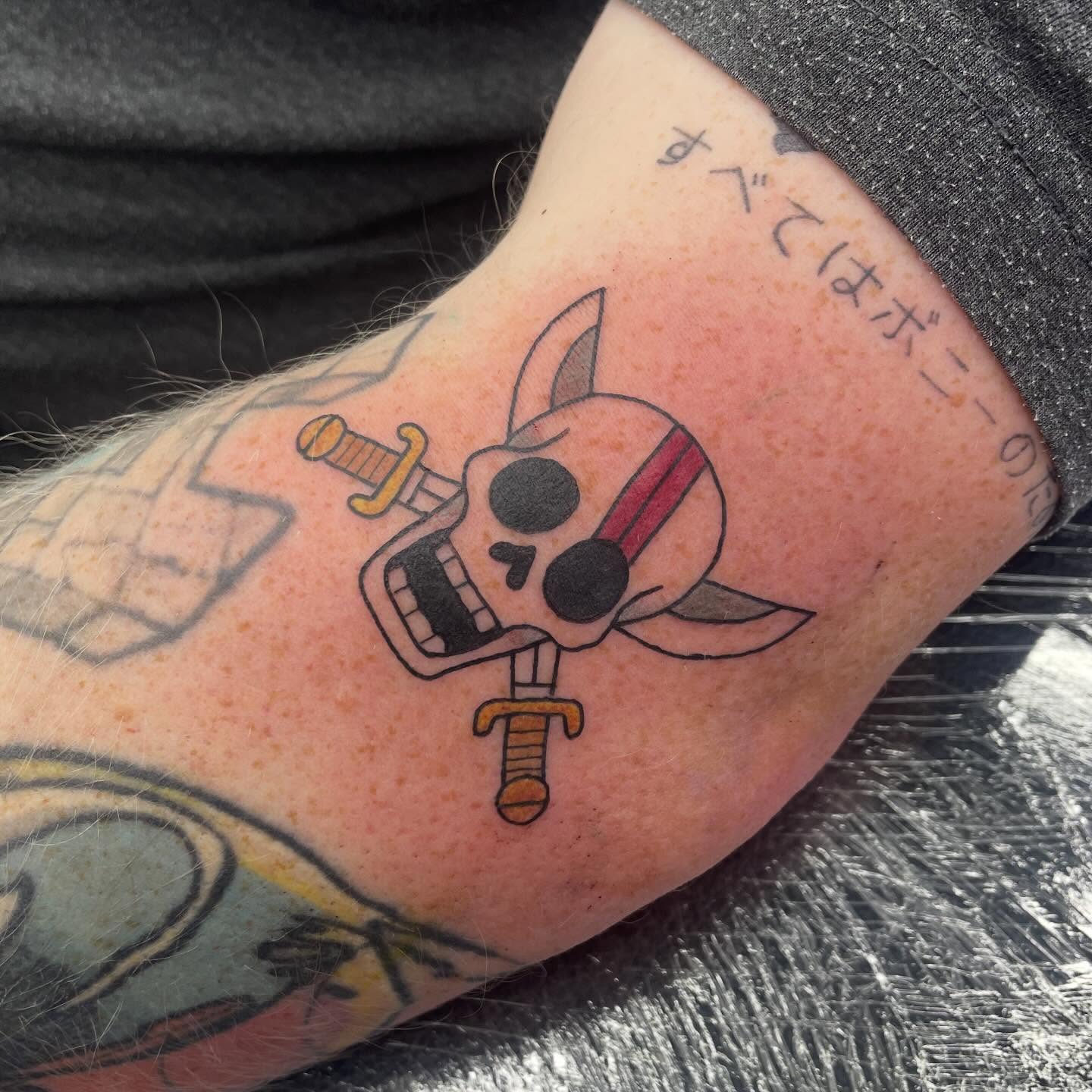 Skull and sword anime tattoo on the forearm by elly, Oakham