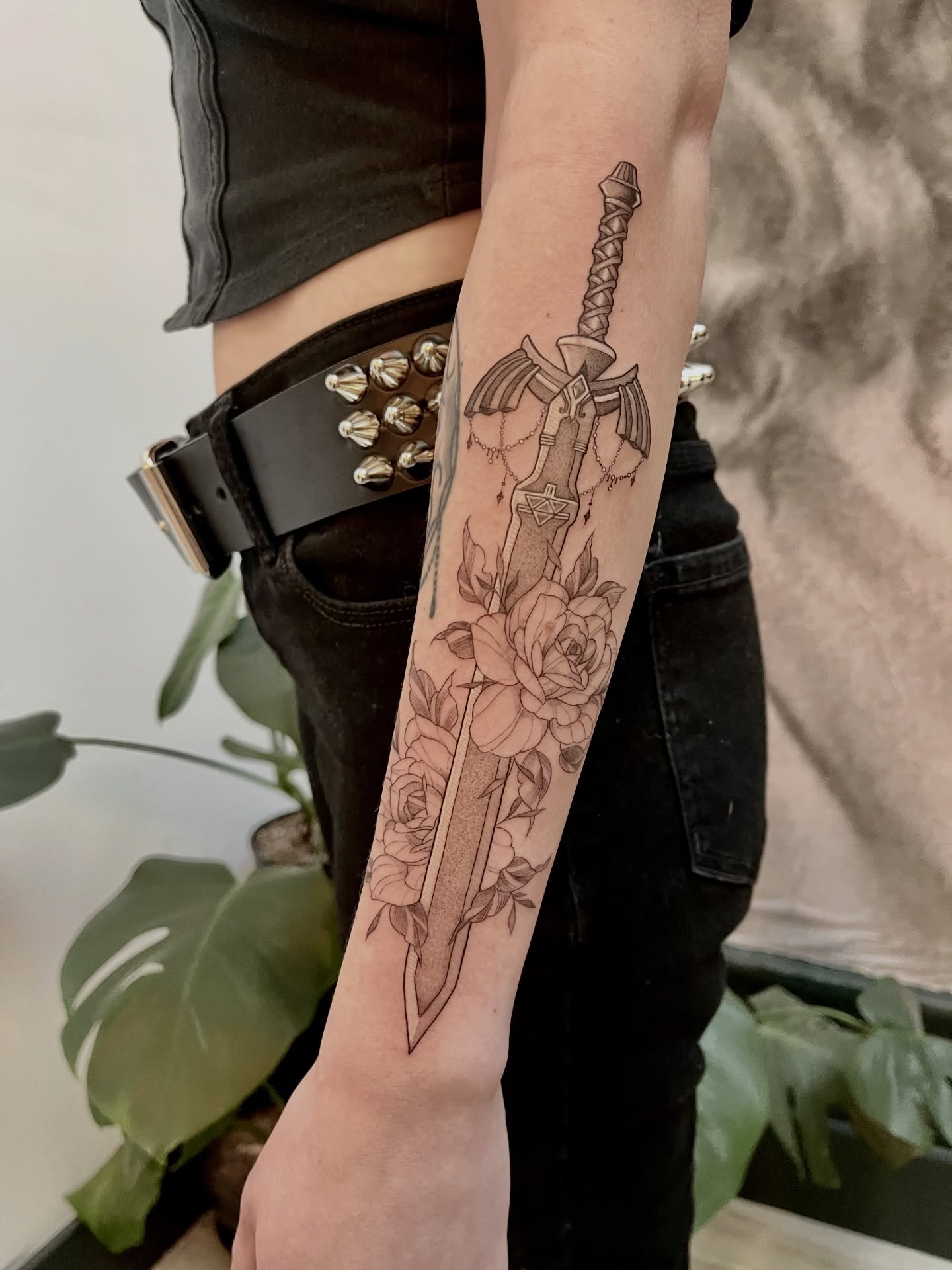 Sword and roses black and grey tattoo on the forearm by Lo Gwynn