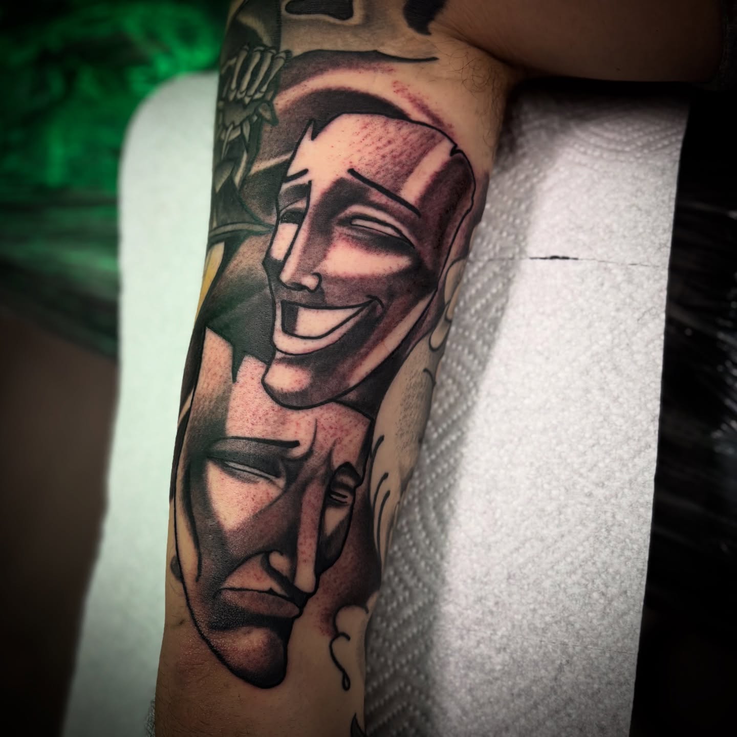 Abstract faces realism tattoo on the forearm by Ogden Tattoo Parlor