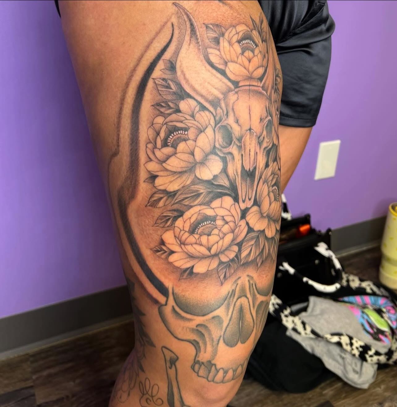 Skull and flowers realism tattoo on the thigh by Ebony Robinson, Austintown, Ohio