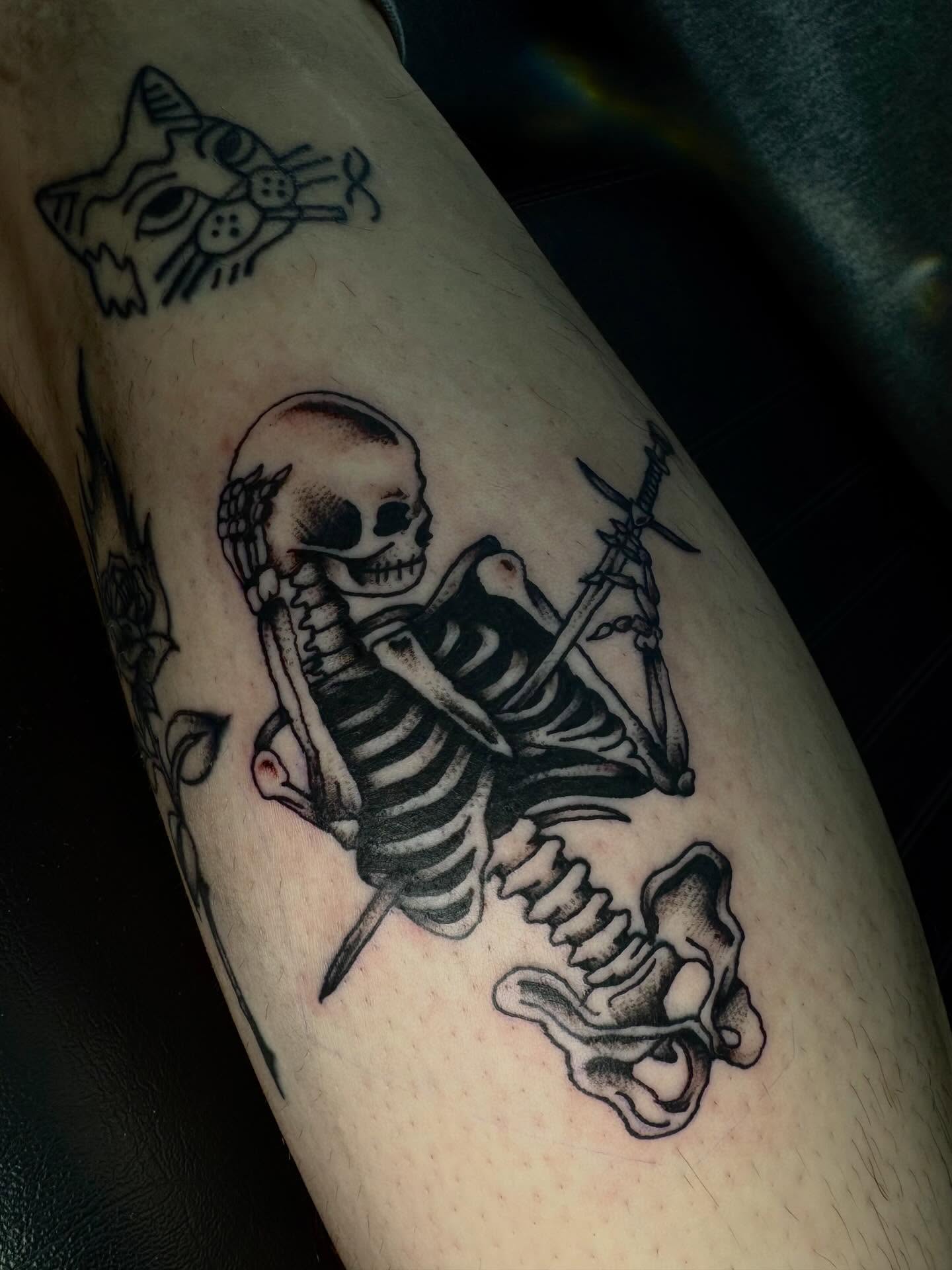Skeleton riding bird black and grey tattoo on the forearm by Jenna Clayton