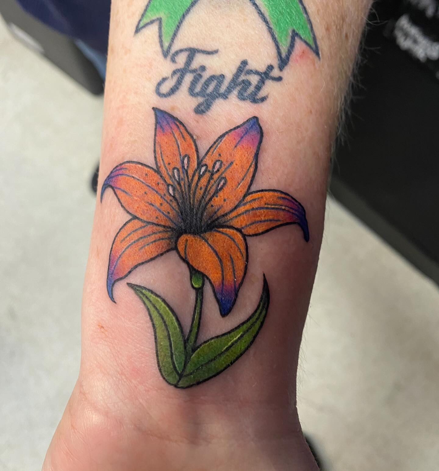 Lily dotwork tattoo on the forearm by Drew