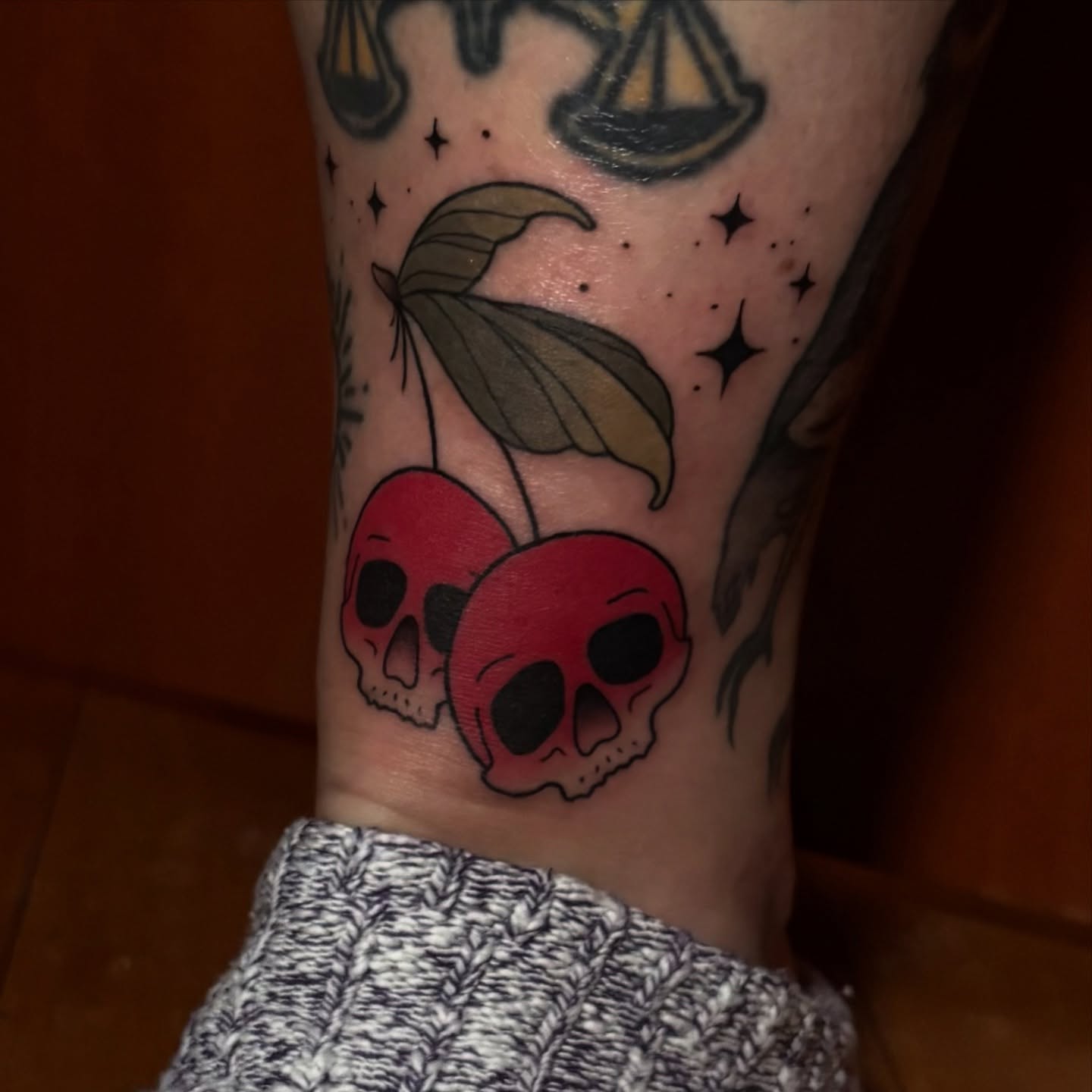Skulls and cherries American traditional tattoo on the forearm by Alicia