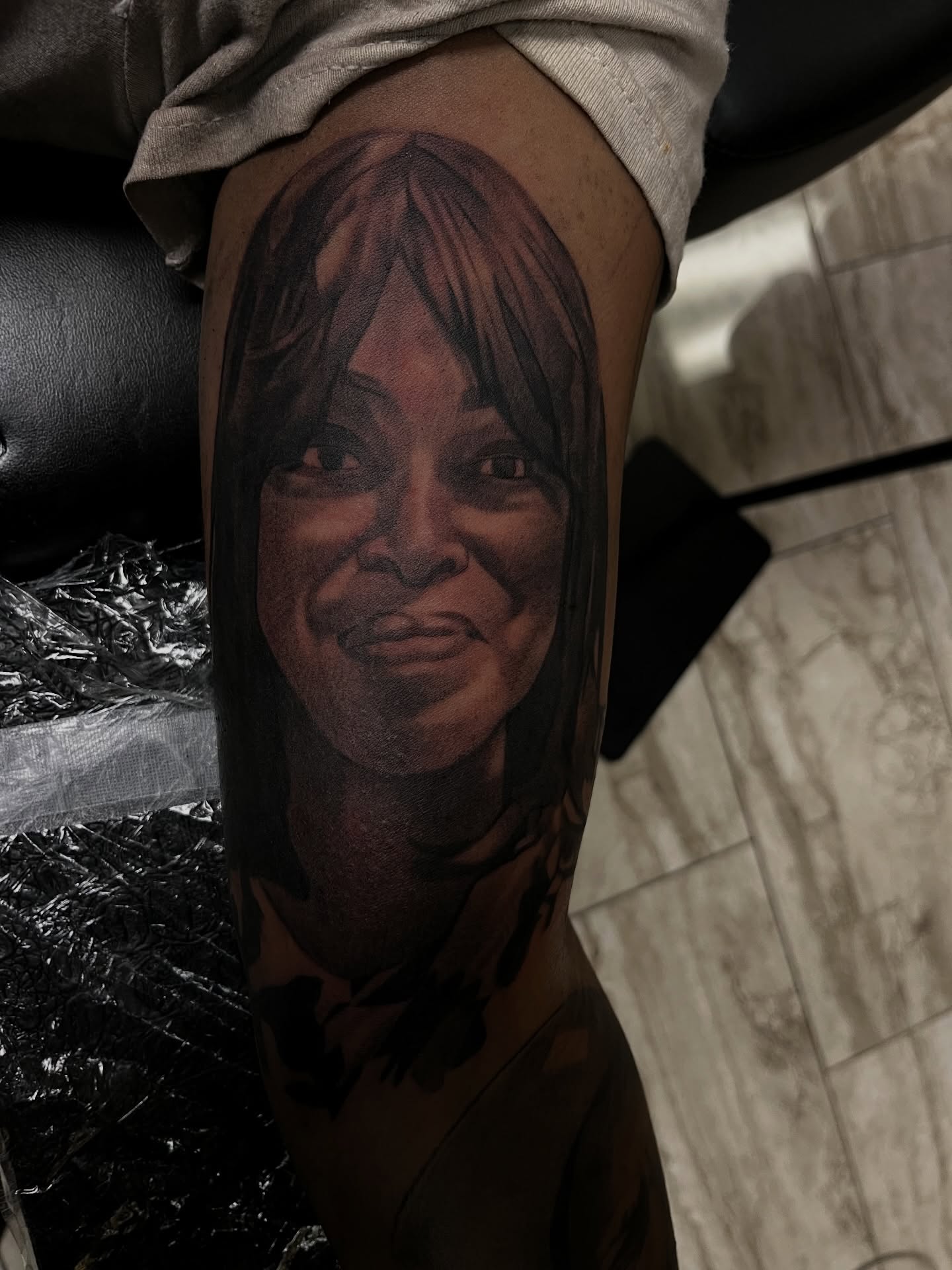 Portrait realism tattoo on the thigh by Quinten Harper