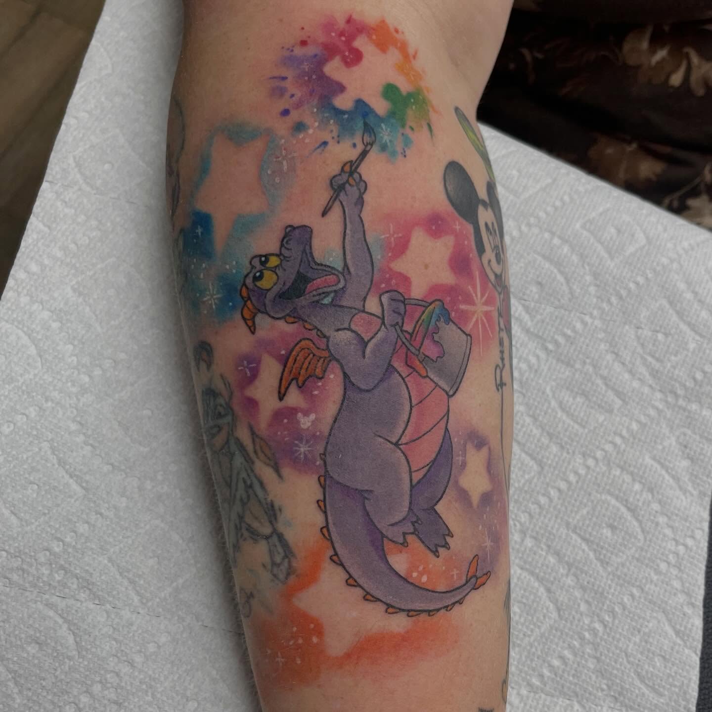 Dinosaur painting watercolor tattoo on the forearm by Tina Gregg, North Ridgeville, Ohio
