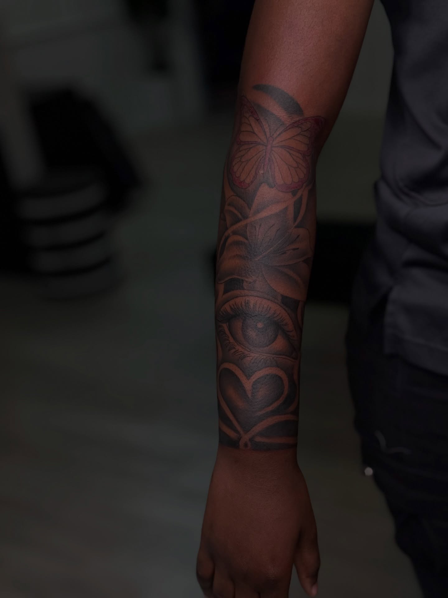 Eye and butterfly realism tattoo on the forearm by Savannah Tattoo Artist