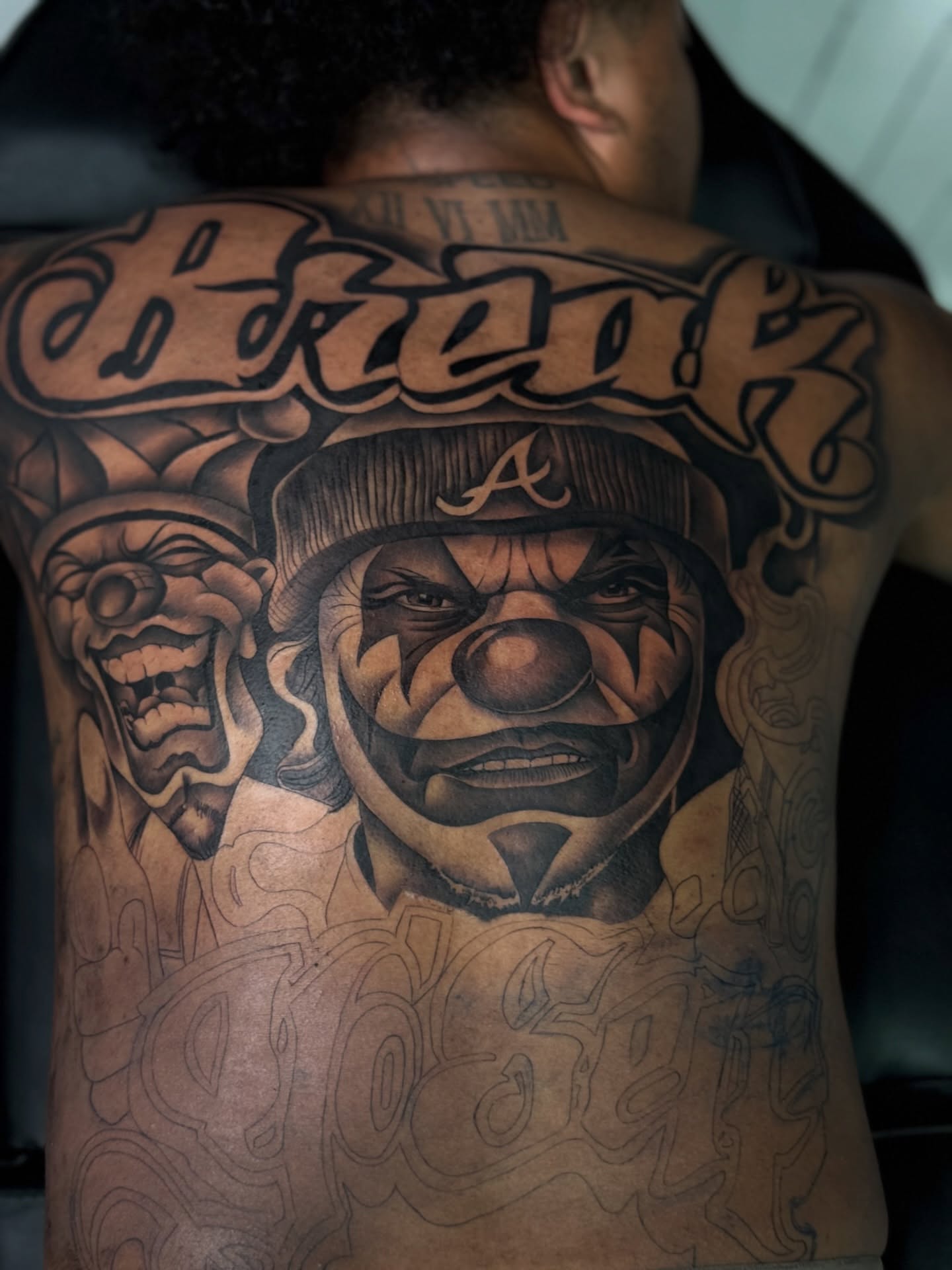 Clown realism tattoo on the back by Savannah Tattoo Artist