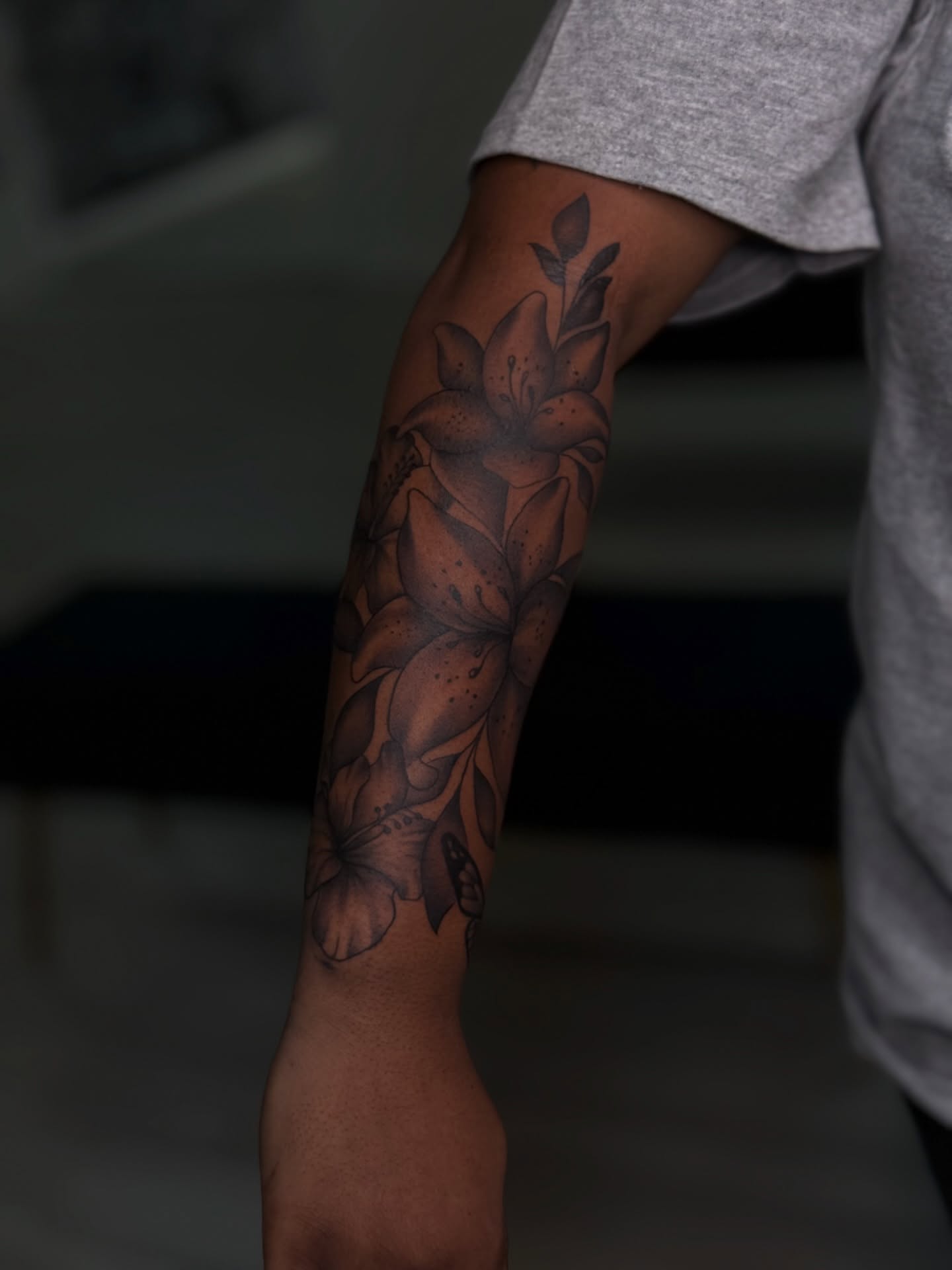 Lily flowers dotwork tattoo on the forearm by Savannah Tattoo Artist