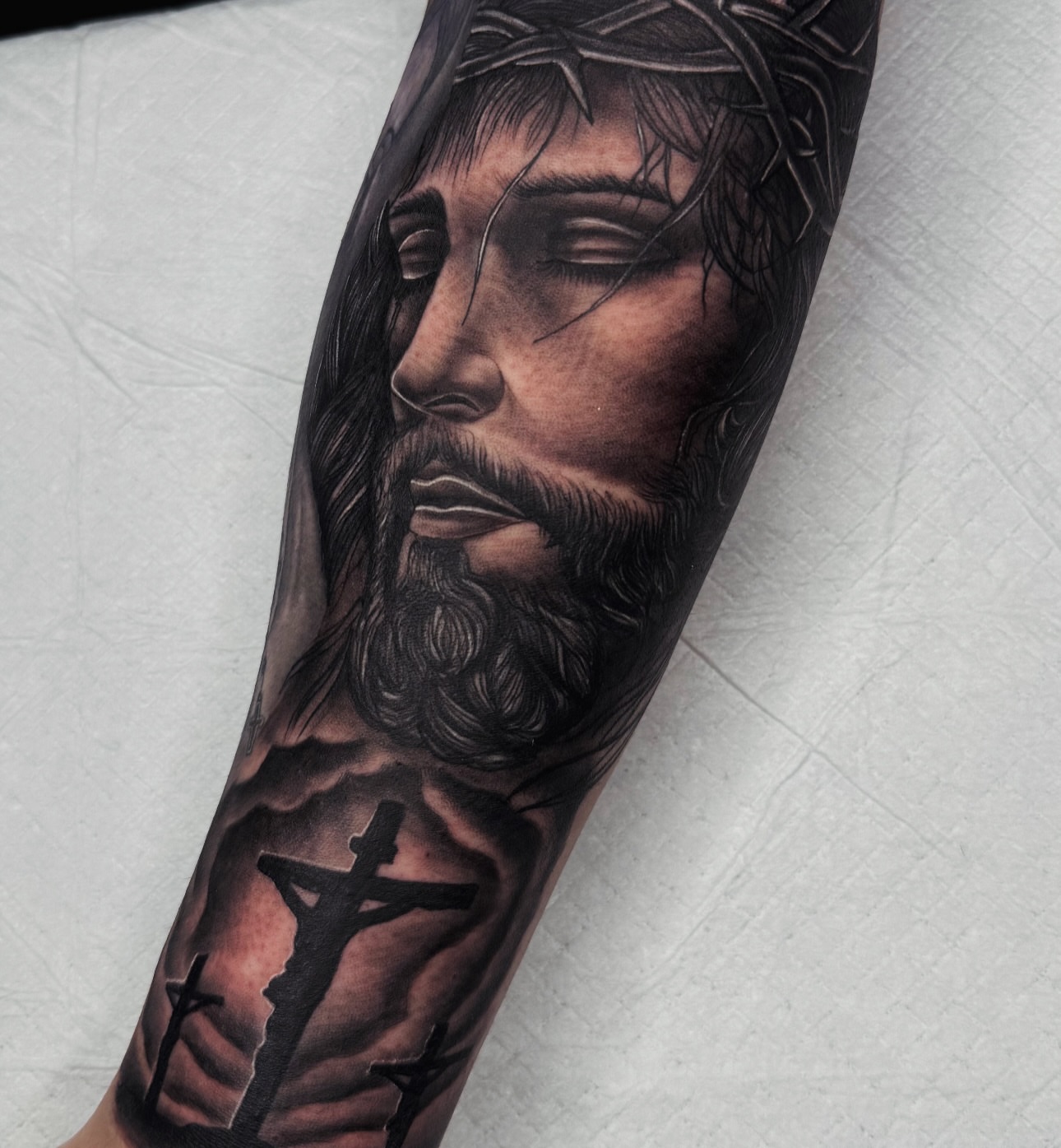 Jesus Christ realism tattoo on the forearm by Elijah East