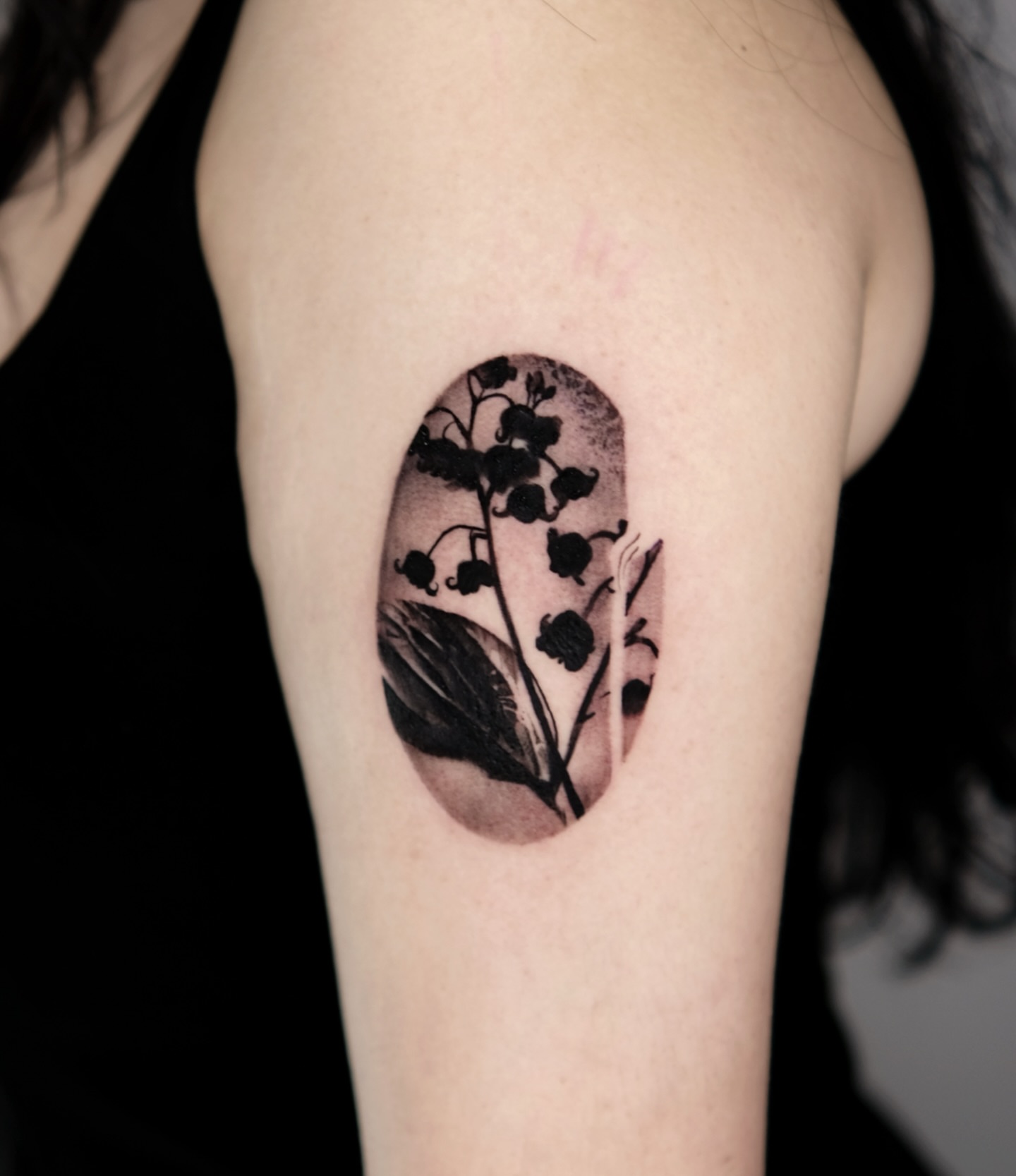 Lily of the valley black and grey tattoo on the shoulder by 𝐌𝐀𝐊𝐒𝐈𝐌 𝐏𝐀𝐓𝐑𝐈𝐂𝐊
