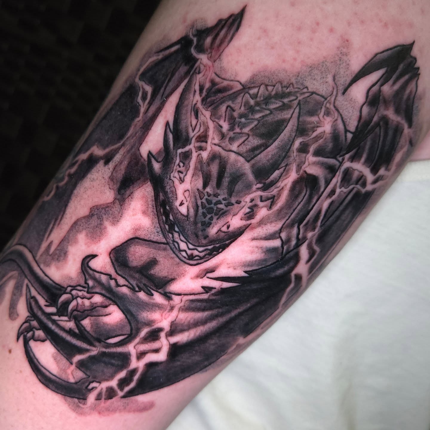 Dragon realism tattoo on the forearm by Nic Mann
