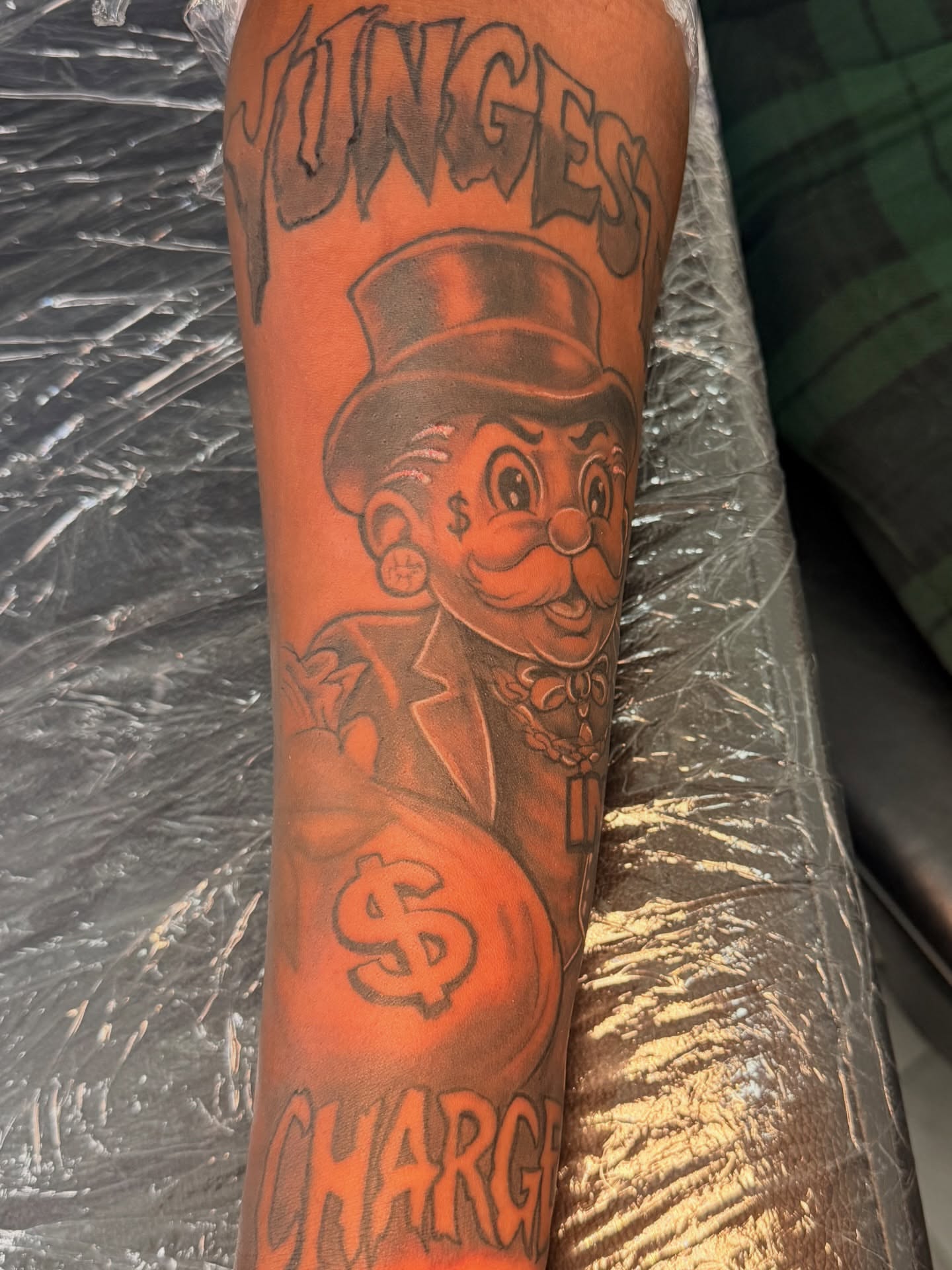 Monopoly man American traditional tattoo on the forearm by InkdByHendrixx