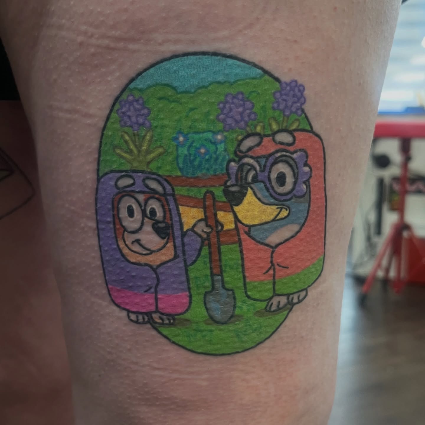 Dog and bird illustrative tattoo on the forearm by Alena McDonald