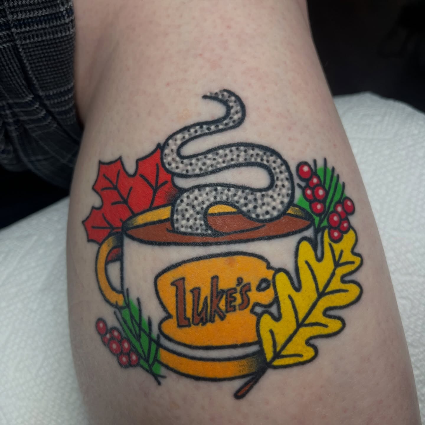 Coffee cup with snake American traditional tattoo on the forearm by Alena McDonald