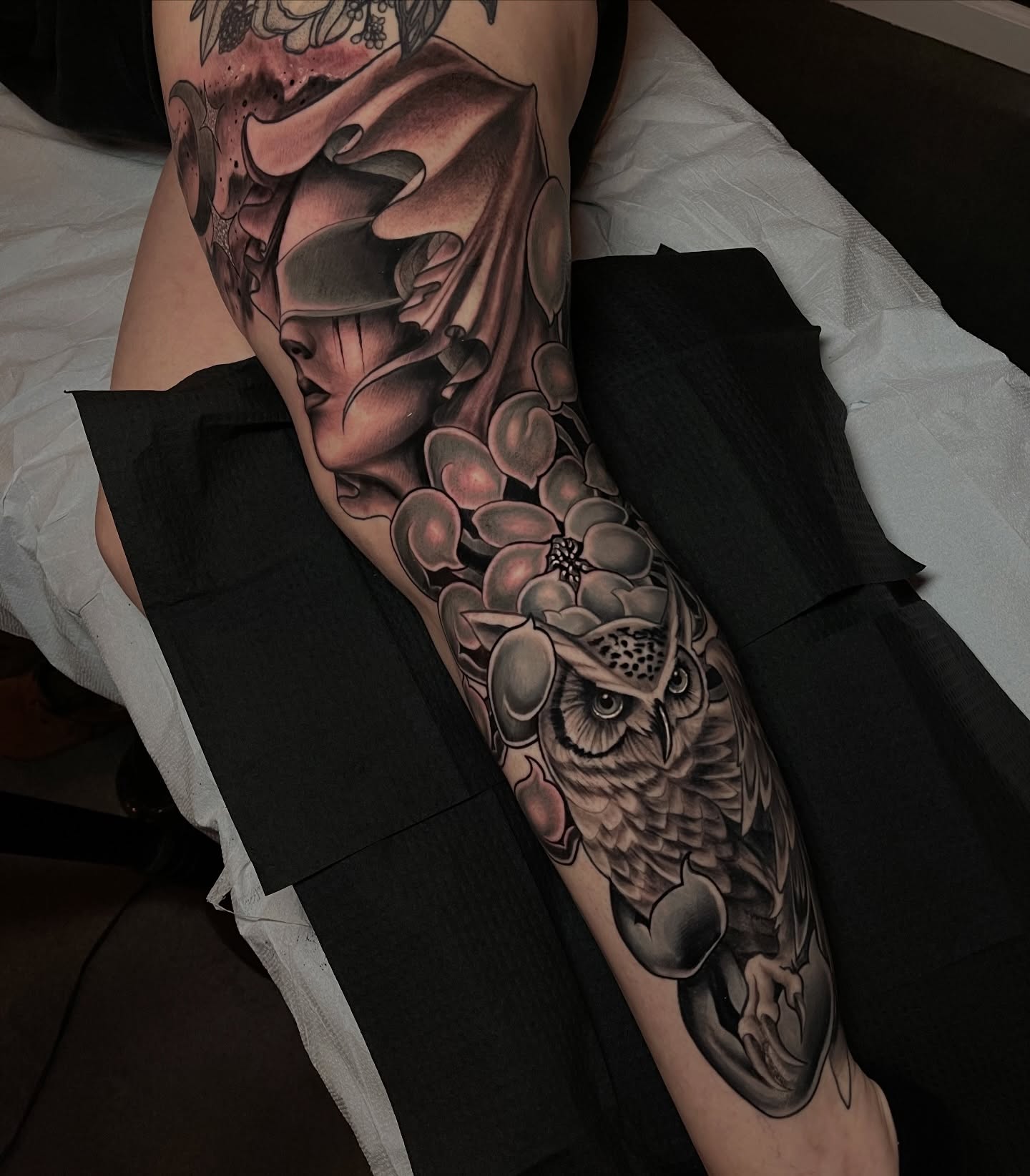 Owl and flowers realism tattoo on the forearm by Corey Ryan