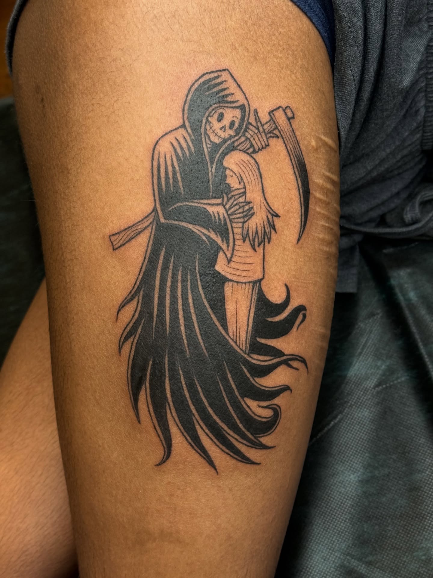 Grim reaper holding child black and grey tattoo on the forearm by Paul DeVay