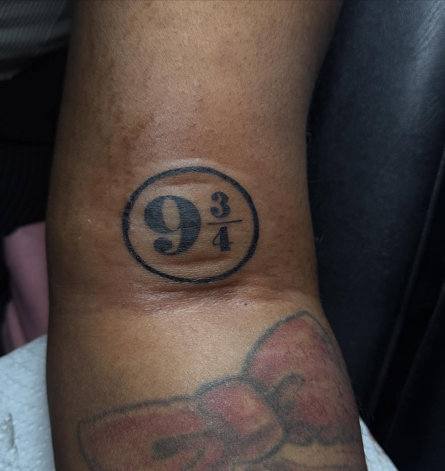 9¾ black and grey tattoo on the forearm by Destini