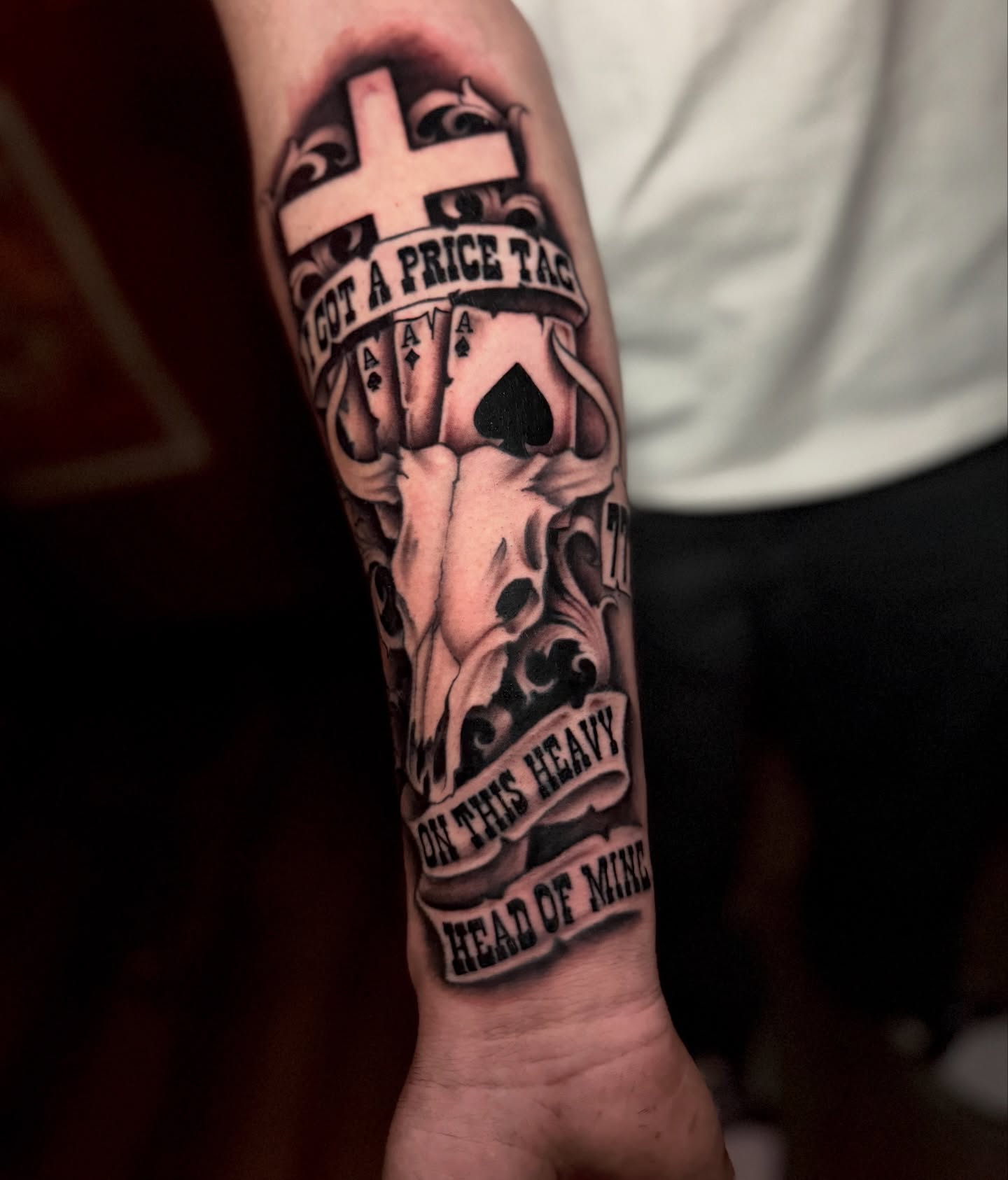 Ace of spades and skull realism tattoo on the forearm by Ryland - Tattoo Artist