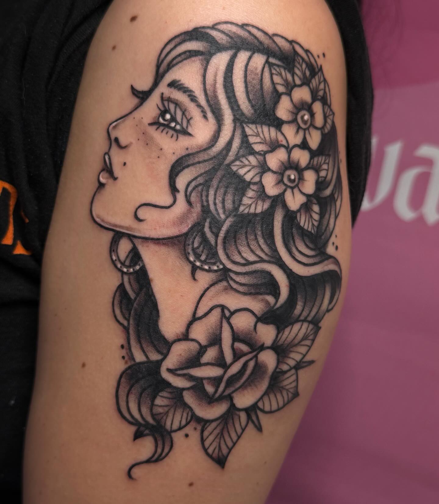 Woman with flowers American traditional tattoo on the shoulder by Chelsea Graham, Seattle, Washington