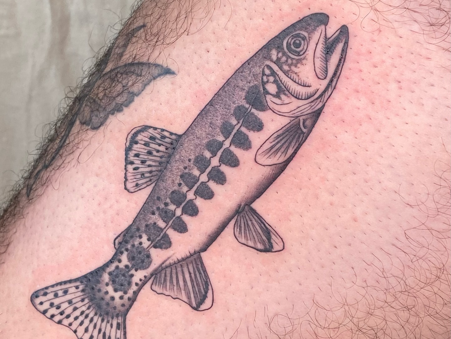 Salmon black and grey tattoo on the thigh by Sasha 🪆 Southern California Tattoo Artist