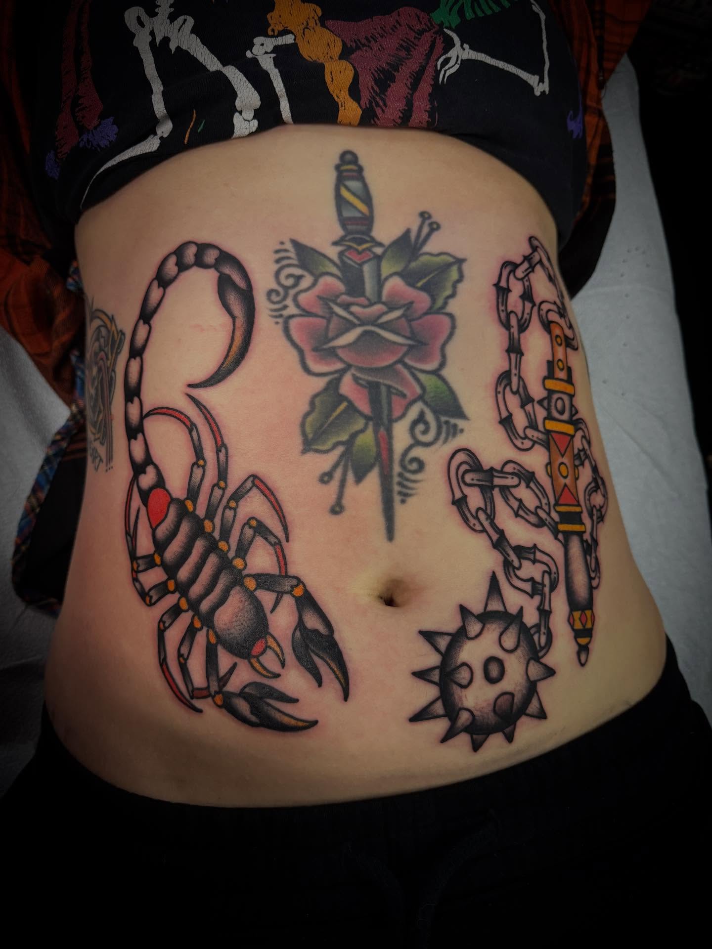 Scorpion, rose, chain, sun American traditional tattoo on the torso by Andrew Slater