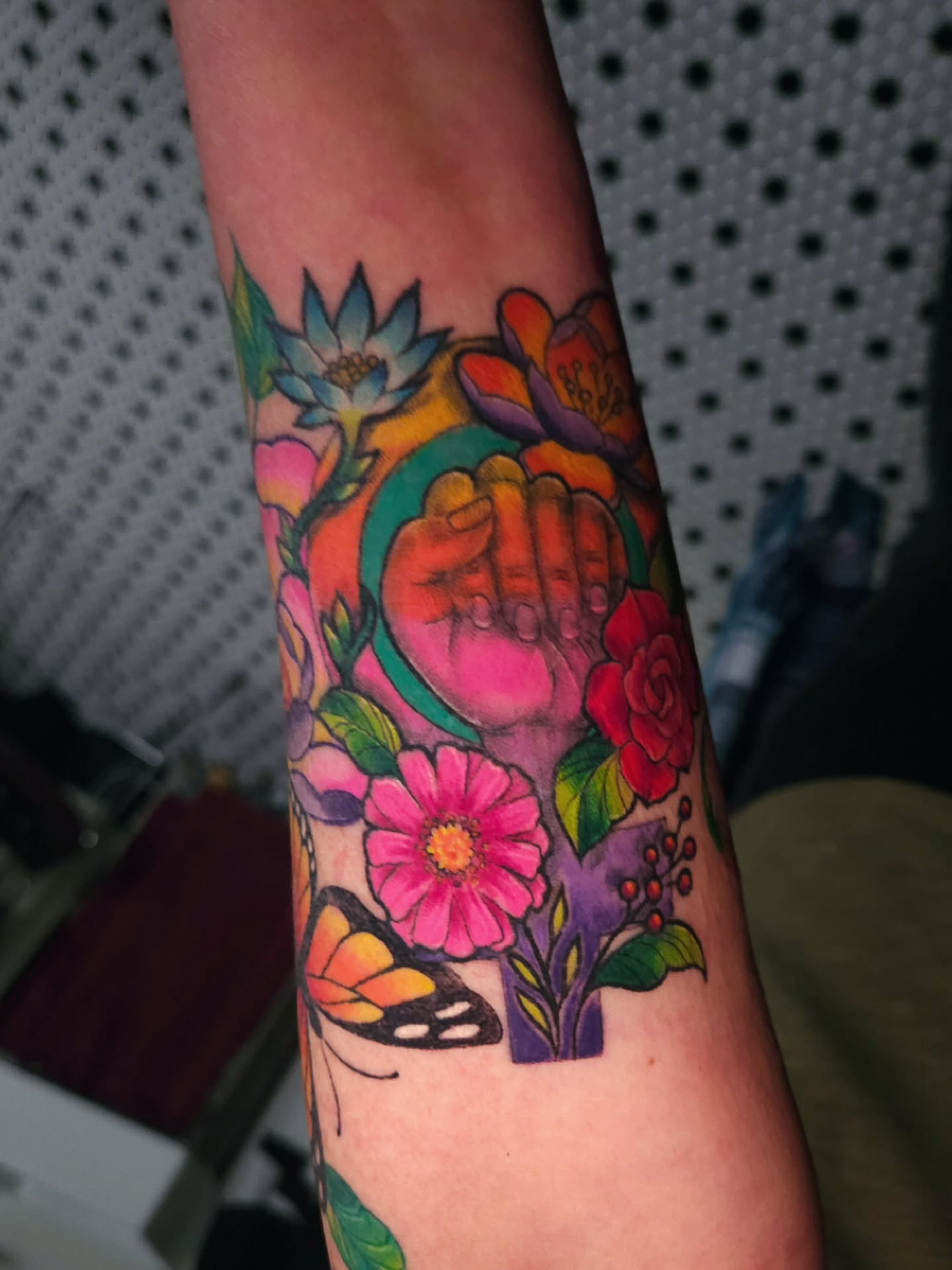 Fist surrounded by flowers new school tattoo on the forearm by ๐๐๐๐