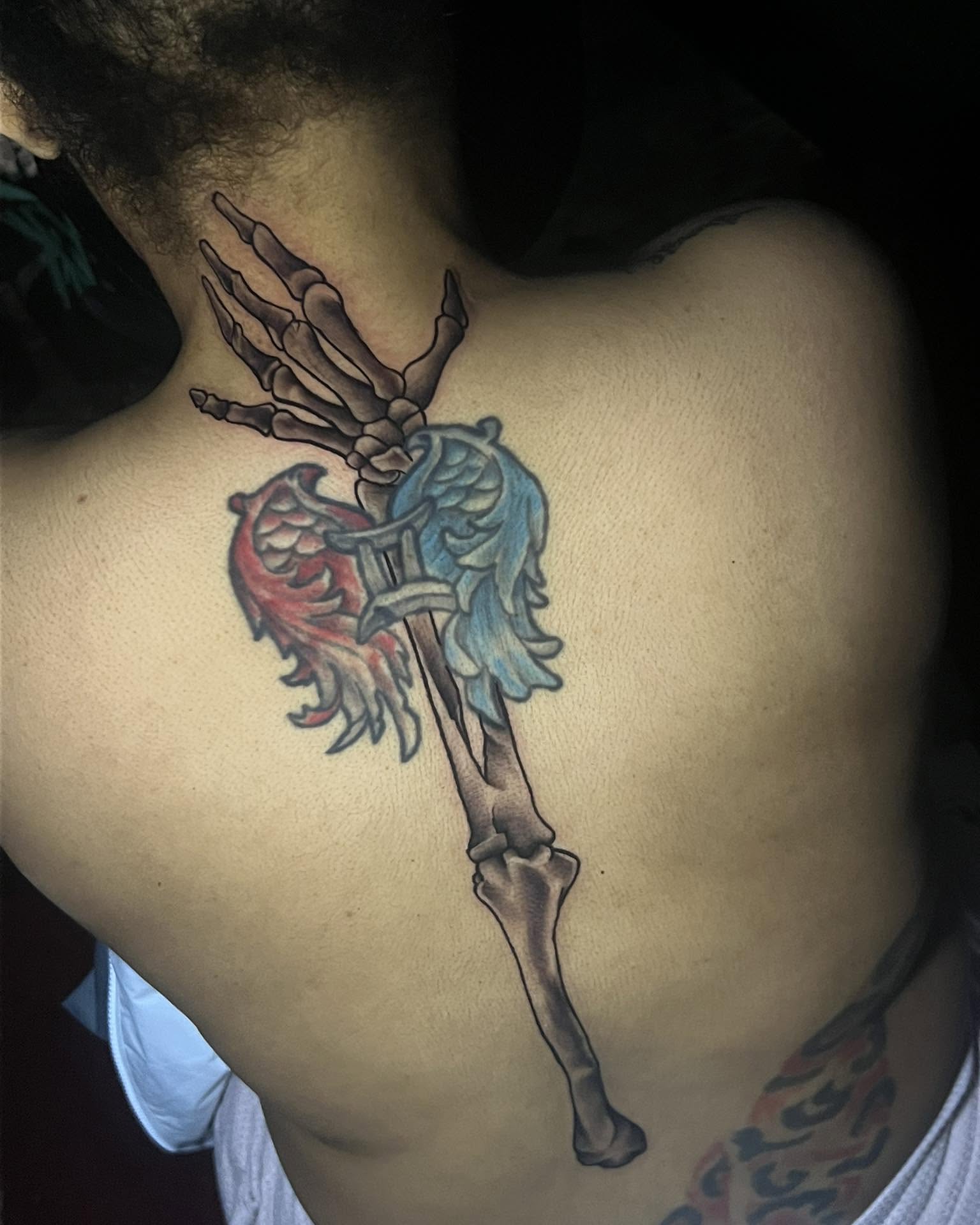 Skeleton hand with wings neo-traditional tattoo on the back by Ferlandis Fitch, Long Beach, California