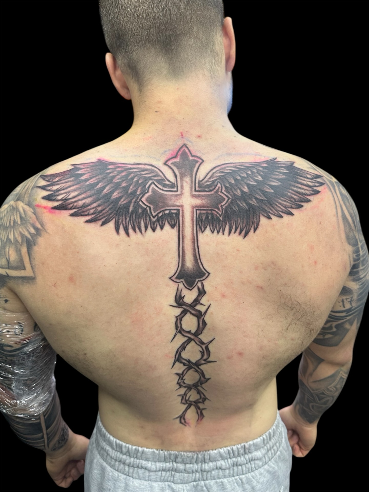 Cross with wings black and grey tattoo on the back by Joe 💭👁