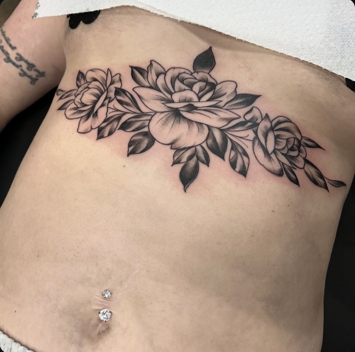 Floral bouquet black and grey tattoo on the ribs by Dylan O'Quin