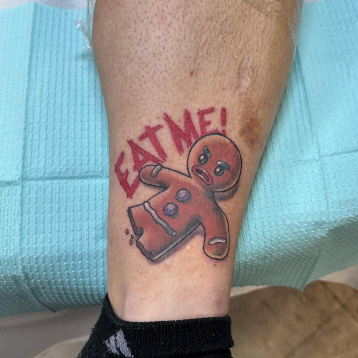 Gingerbread man dotwork tattoo on the forearm by Jordanna Pearl