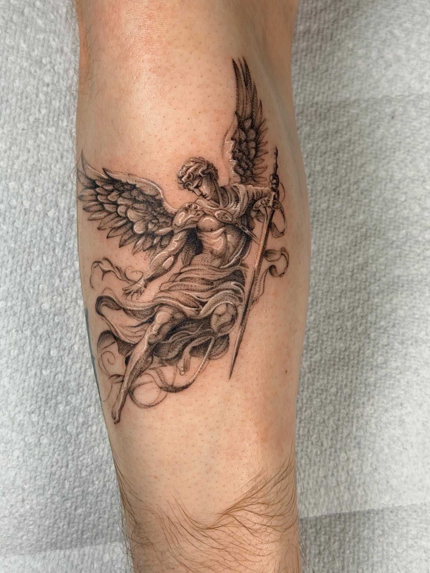 Winged angel black and grey tattoo on the forearm by Nate Weaver