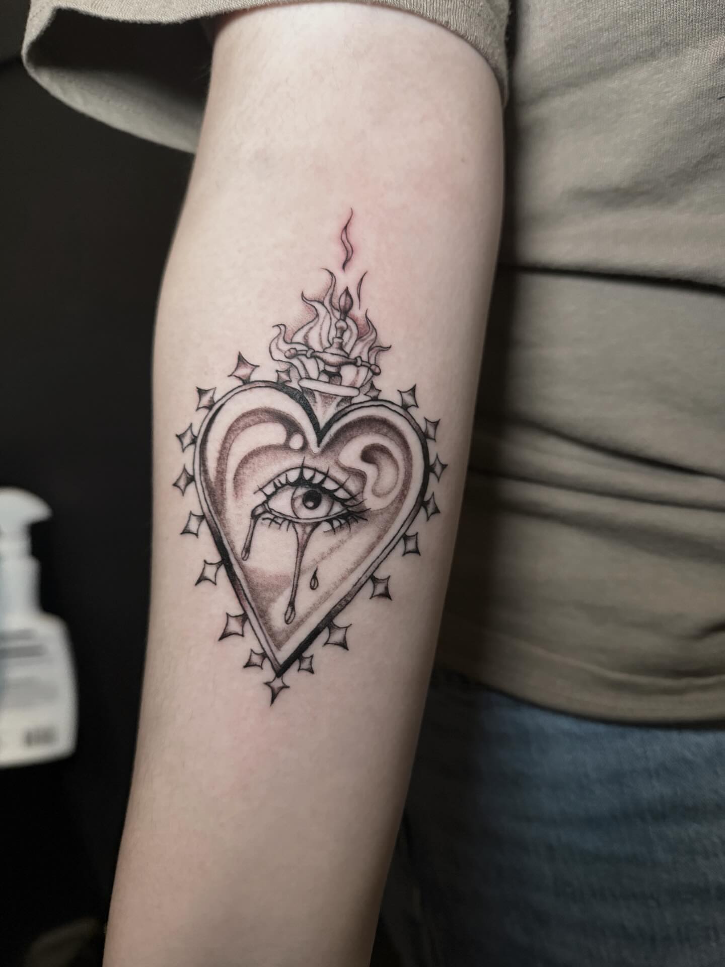 Heart with eye black and grey tattoo on the forearm by Jess, Midvale, Utah