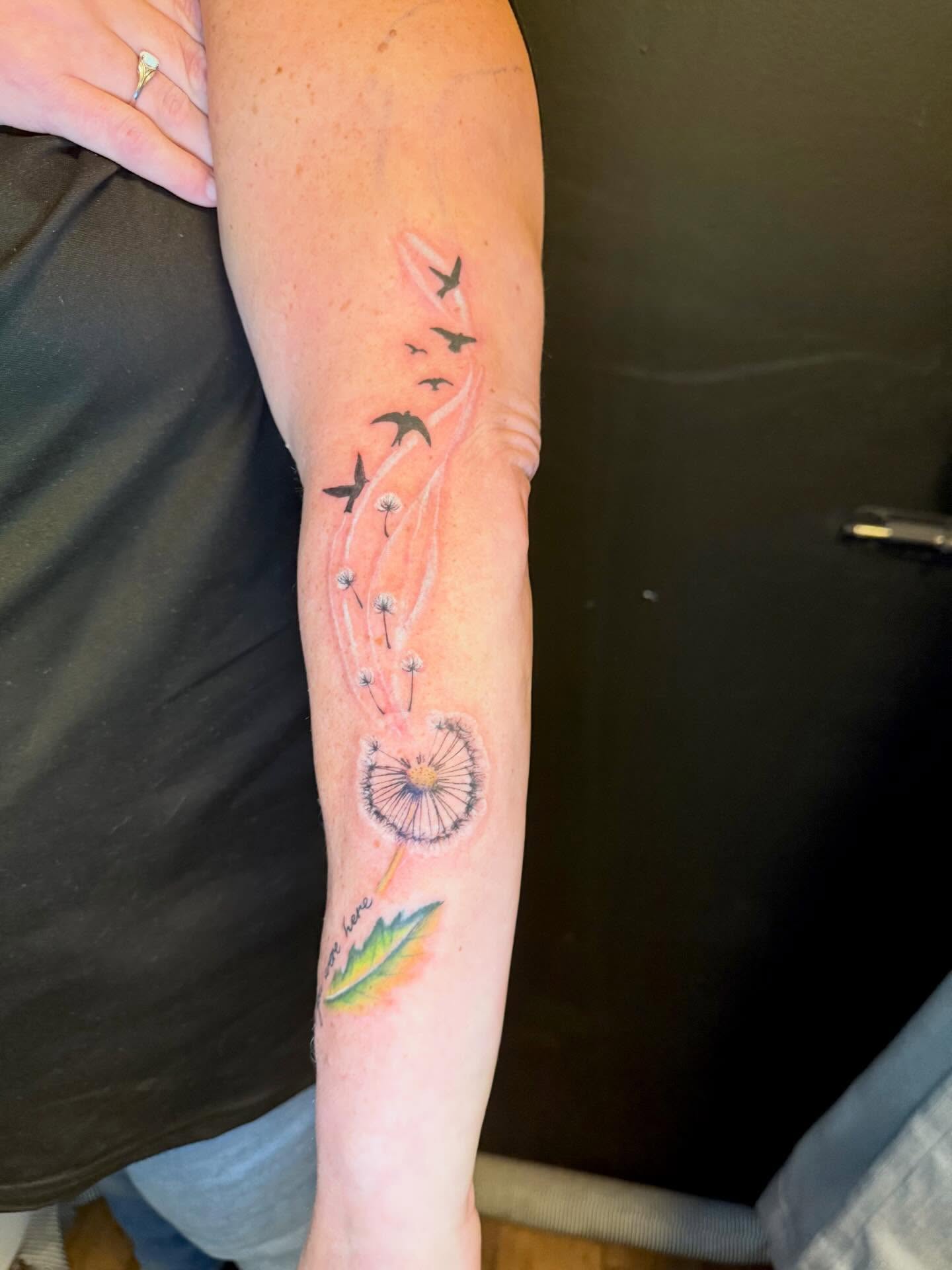 Dandelion seeds watercolor tattoo on the forearm by Paul Calhoun Tattoos, Englewood, Ohio