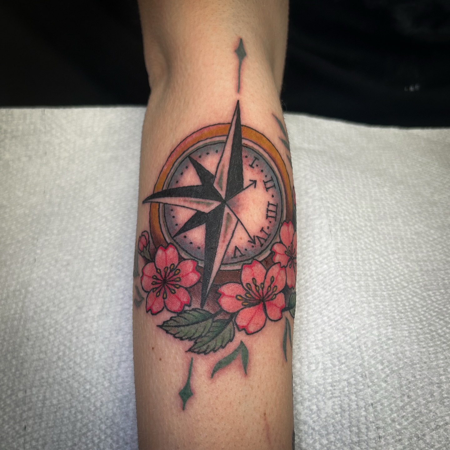Compass and cherry blossoms geometric tattoo on the forearm by Jessica Oram Brockman, Dayton, Ohio