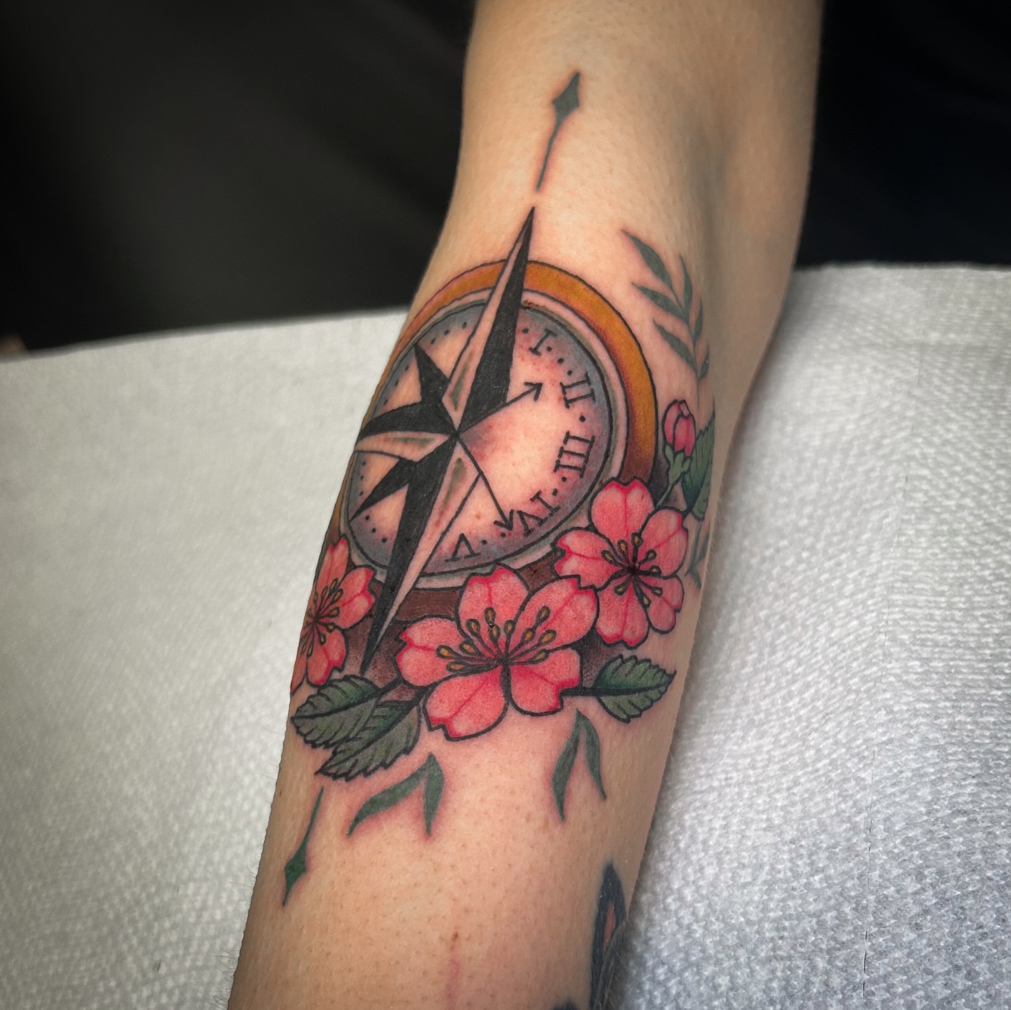 Compass and cherry blossoms new school tattoo on the forearm by Jessica Oram Brockman, Dayton, Ohio