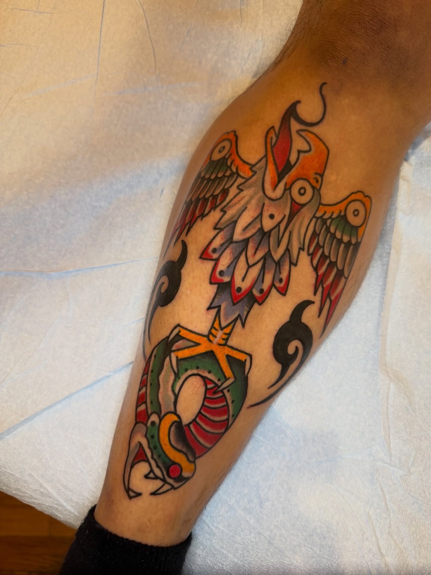Bird and fish American traditional tattoo on the forearm by Kevin R. Onley